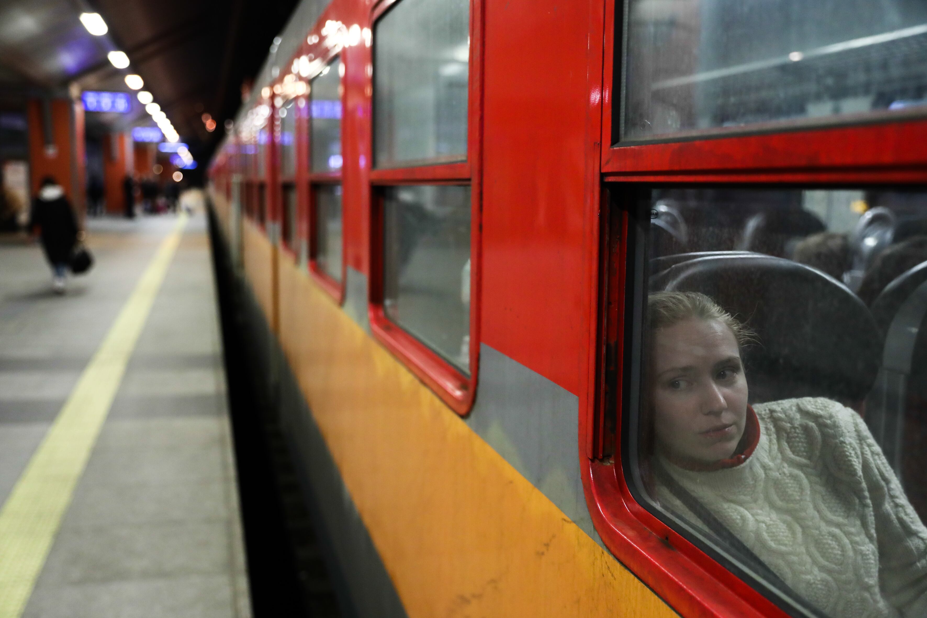 A woman fleeing from Ukraine looks through the train's window at the train station in Krakow, Poland on March 14, 2022. Thousends of refugees from Ukraine come to Poland after the Russian invasion.  (Photo by Jakub Porzycki/NurPhoto via Getty Images)