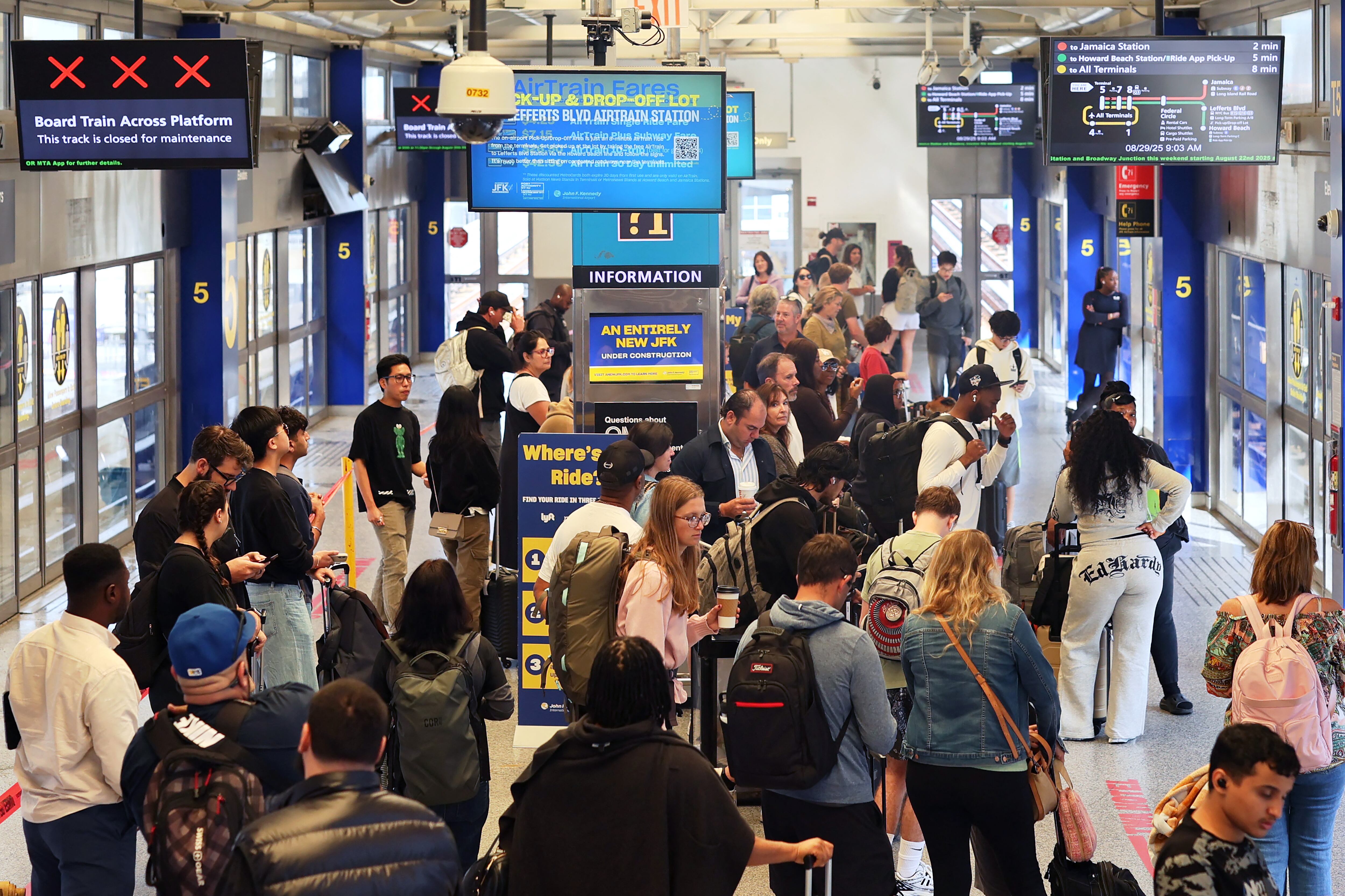 NEW YORK, NEW YORK - AUGUST 29: People wait for the Airtrain in Terminal 5 at JFK Airport on August 29, 2025 in New York, New York. The Port Authority says about 2.4 million people are expected to travel through the region�s major airports in Newark, JFK, and LaGuardia during the Labor Day holiday travel period, setting a new record.   Michael M. Santiago/Getty Images/AFP (Photo by Michael M. Santiago / GETTY IMAGES NORTH AMERICA / Getty Images via AFP)
