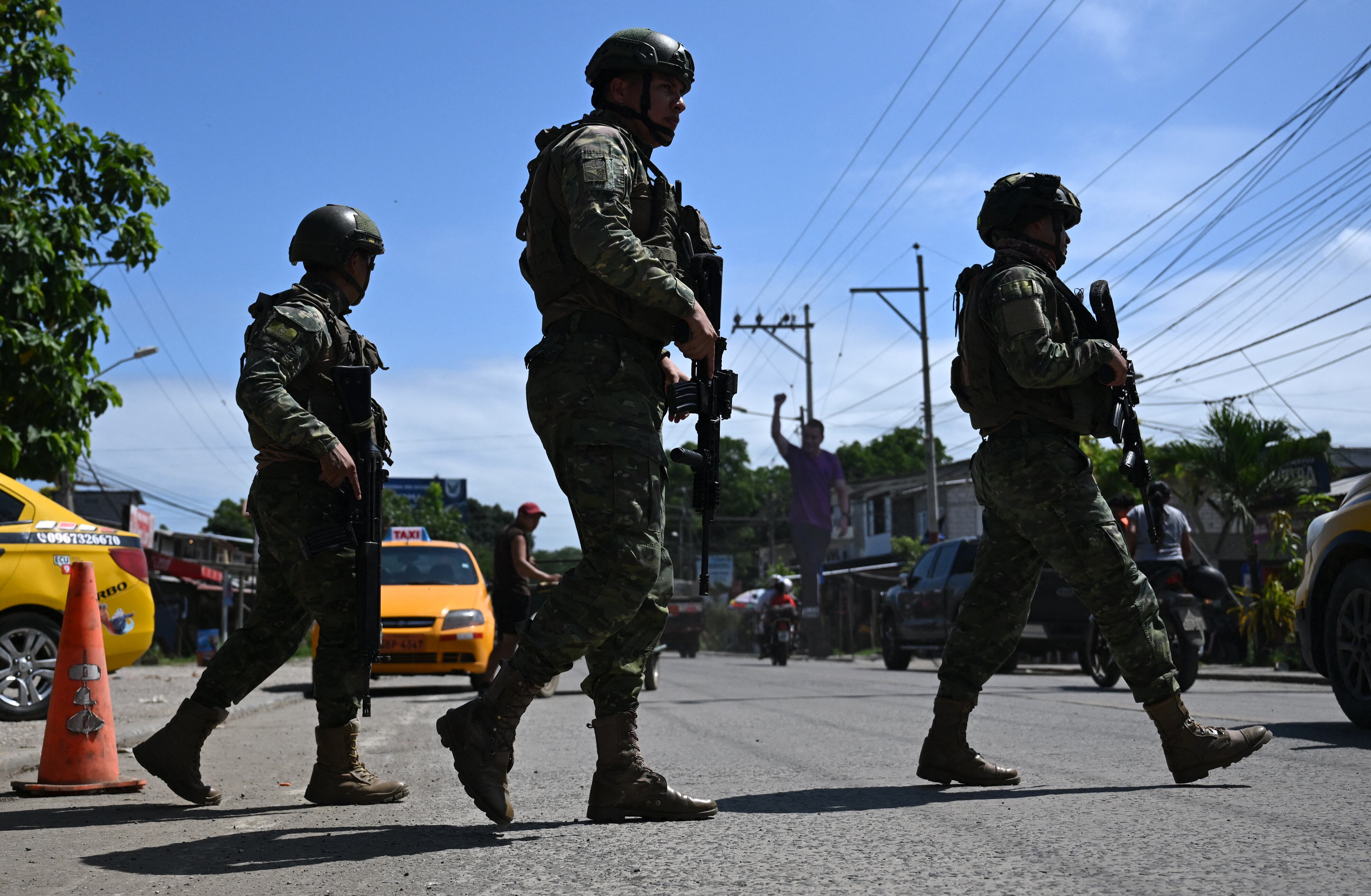 Ecuadorian soldiers patrol the street in Olon, Santa Elena province, Ecuador, on April 14, 2025, the day after the presidential runoff election. Ecuador's President Daniel Noboa claimed a runaway reelection victory after campaigning on a promise to take an "iron fist" to the country's drug cartels. (Photo by Raul ARBOLEDA / AFP) (Photo by RAUL ARBOLEDA/AFP via Getty Images)          