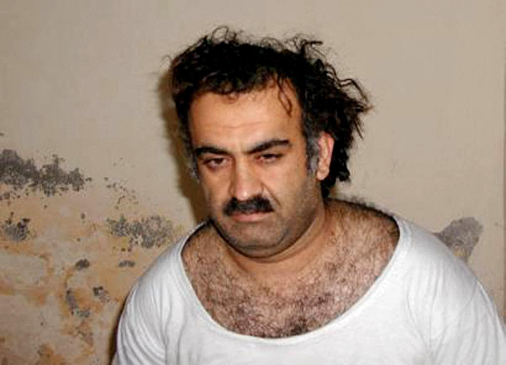 This photo obtained 01 March, 2003, shows, Khalid Sheikh Mohammed, alleged organizer of the September 11, 2001, attacks, shortly after his capture. US officials investigating the murder of Wall Street Journal reporter Daniel Pearl now believe he was personally slain by Mohammed. The Journal reported 21 October, 2003, that White House administration officials had developed credible, corroborated information that Mohammed was "directly involved" in Pearl's murder. Pearl was kidnapped on January 23 last year in the Pakistani city of Karachi where he was investigating Islamic militancy. A scratchy video of Pearl's throat being cut was delivered to the US consulate on February 21. It took until May 2002 to find his remains. AFP PHOTO/HO (Photo by HO / AFP)