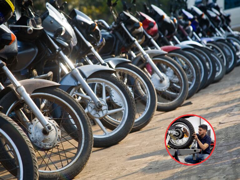 Varias motos y de fondo un mecánico revisando la llanta de una notocicleta (Fotos vía Getty Images).
