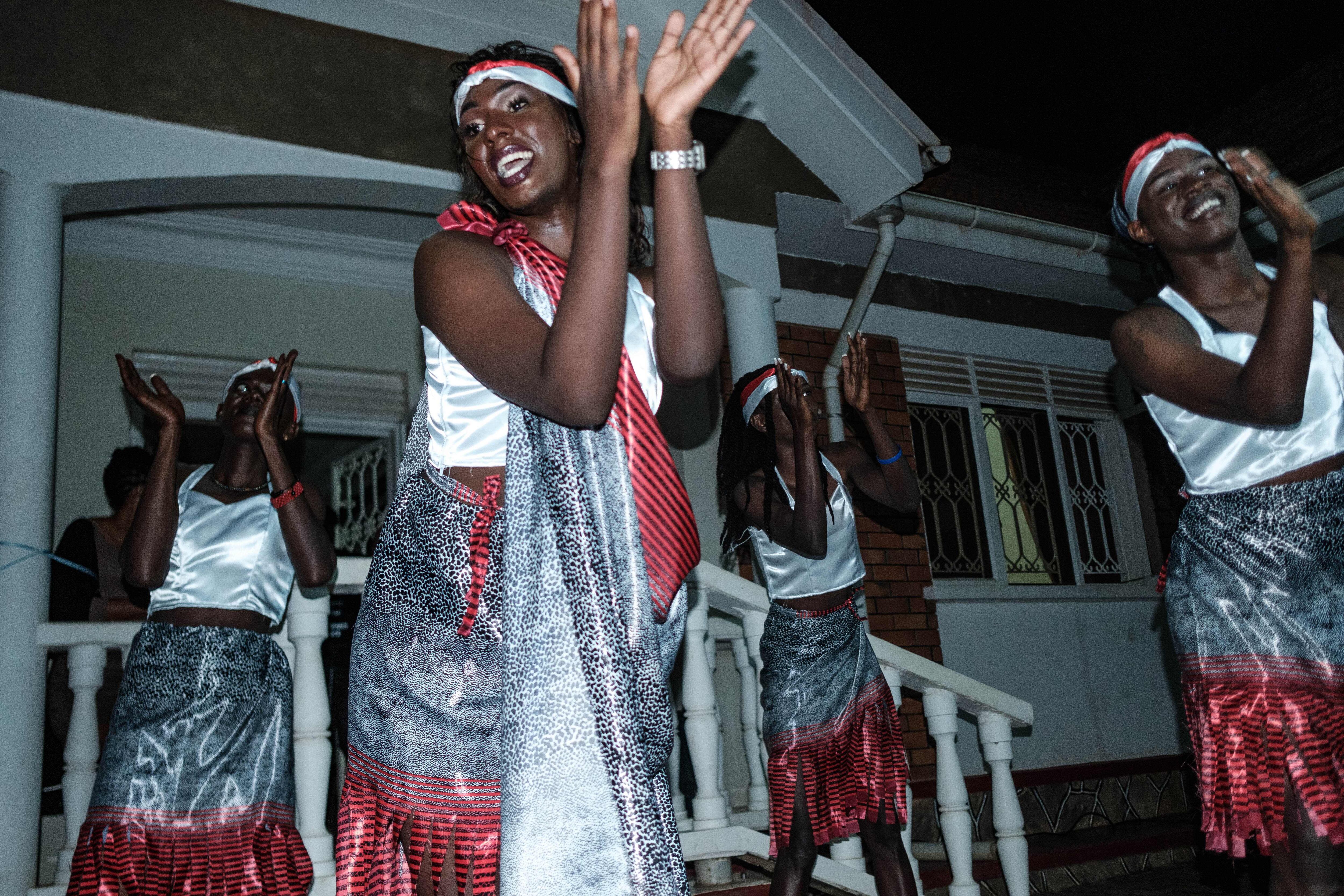 Members of the transgender and LGBTQ community dance during the Transgender day of Remembrance in order to pay tributes to victims of hate crimes in Uganda and all over the world, in Kampala, Uganda, on November 23,2019. - The event comes after a number of attacks on the LGBTQ community in Uganda in recent months, and follows the arrest of 120 people in a raid on an LGBTQ-friendly nightclub in Kampala on November 10, 2019. A colonial-era law outlaws gay sex in the country, many LGBTQ people continue to be victims of violence from hate crimes. (Photo by Sumy SADRUNI / AFP) (Photo by SUMY SADRUNI/AFP via Getty Images)