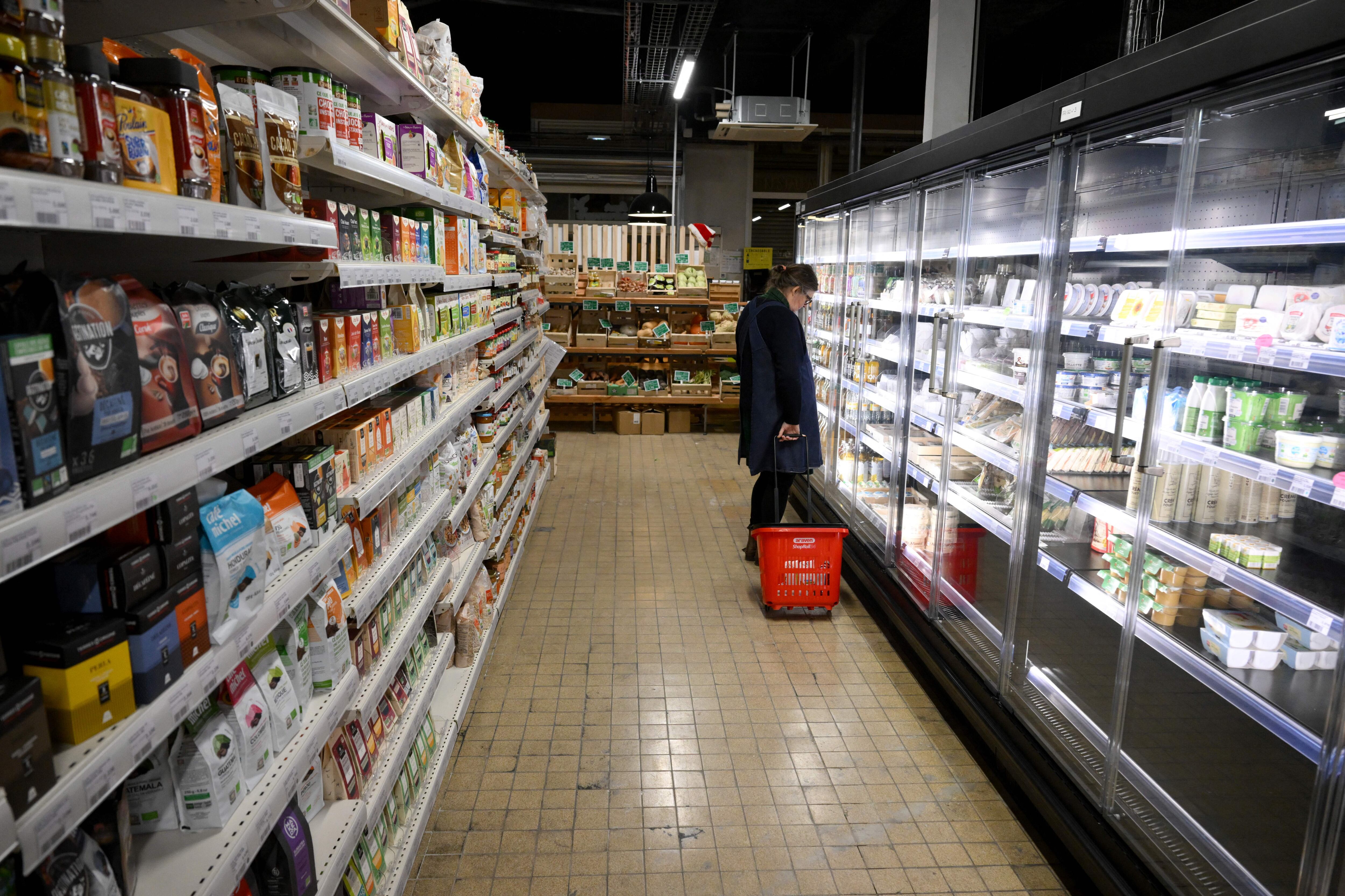 A customer shops at the "Super Cafoutch", a cooperative and participative supermarket in Marseille, southern France, on January 19, 2023. - The "Super cafoutch", where customers are also co-owners, is the first cooperative supermarket in Marseille, and offers an alternative to large-scale distribution for consumers in search of meaning and low prices. (Photo by Nicolas TUCAT / AFP) (Photo by NICOLAS TUCAT/AFP via Getty Images)
