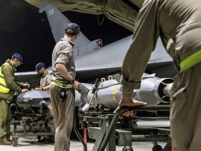 A handout picture released by the British Ministry of Defence (MOD) on February 24, 2024 shows a Royal Air Force Typhoon FGR4 having Paveway IV weapons loaded by Weapon Technicians at RAF Akrotiri in Cyprus, in preparation for a strike on military targets in Yemen. AFP.