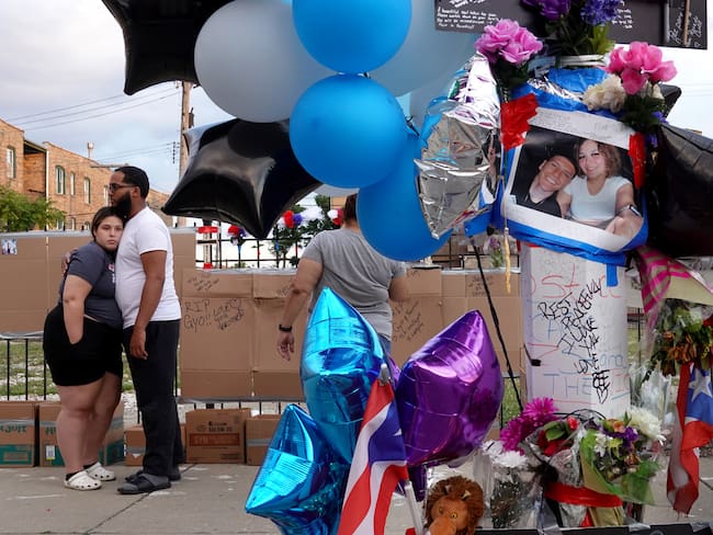CHICAGO, ILLINOIS - JUNE 22: Mourners gather to remember Gyovanni Arzuaga, 24, and Yasmin Perez, 25, at a makeshift memorial at the location where both were shot during an altercation following a minor traffic accident as they celebrated their Puerto Rican heritage Saturday in the Humboldt Park neighborhood on June 22, 2021 in Chicago, Illinois. Arzuaga was rushed to the hospital with a gunshot would to the head where he was pronounced dead on Saturday. Perez died today from a gunshot wound to the neck. The young couple leave behind two children. (Photo by Scott Olson/Getty Images)