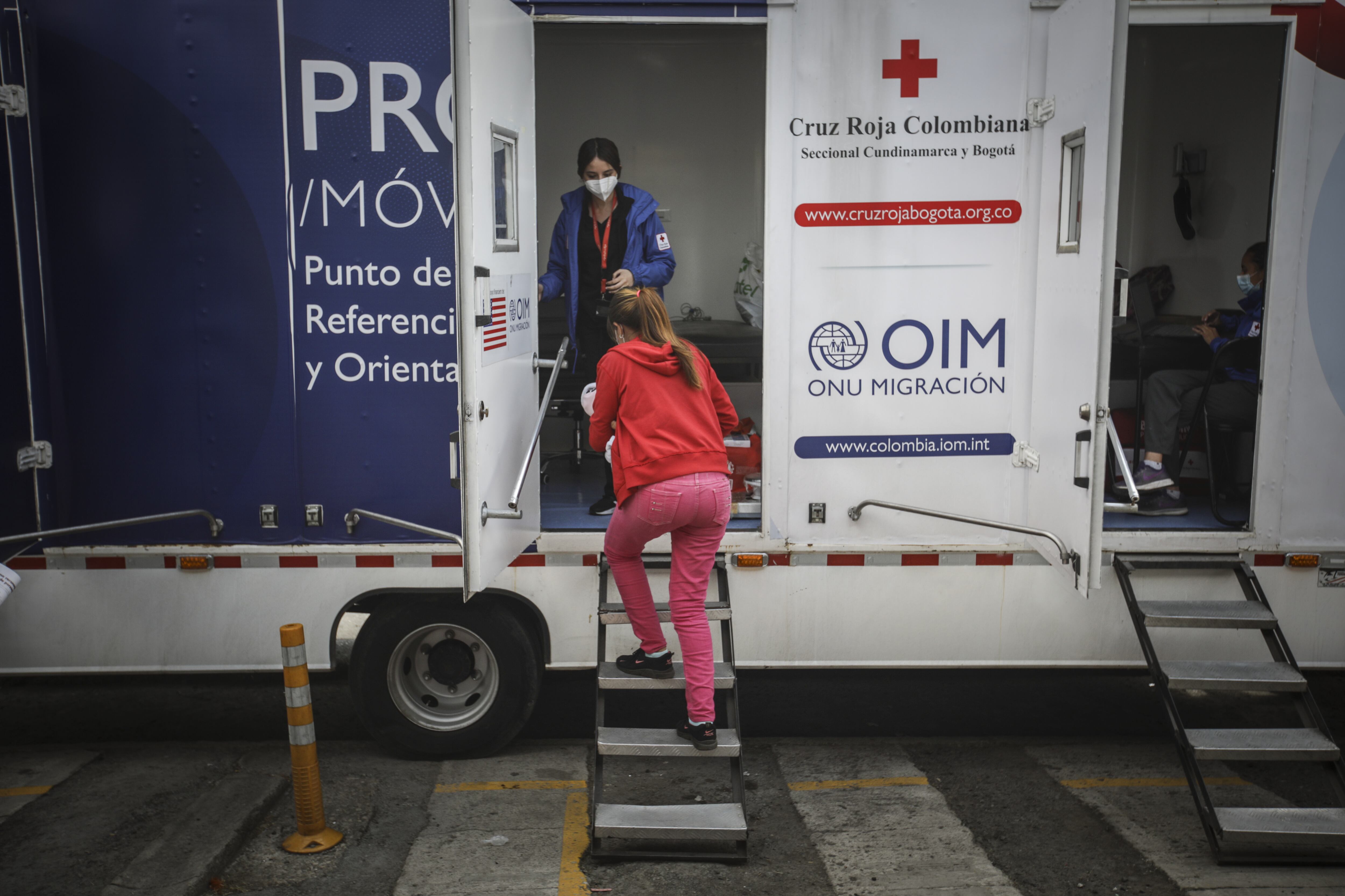 SIBATE, COLOMBIA - DECEMBER 21: A group of Venezuelan migrants gather for food, medical aid at the International Red Cross, UN Refugee Agency, before continuing the march by foot to find countries like Ecuador, Peru, and Chile at the immigrant aid center on the roads in Sibate, Colombia on December 21, 2021. Shelters in Colombia are preparing for increasing numbers of impoverished migrants arriving on foot after Venezuela reopened its border with its Andean neighbor, many of them children in need of food, medical attention. Venezuelan President Nicolas Maduro's government said this month it was reopening its side of the 2,219-km (1,379-mile) border with Colombia, which was closed in 2019 over political tensions. (Photo by Juancho Torres/Anadolu Agency via Getty Images)