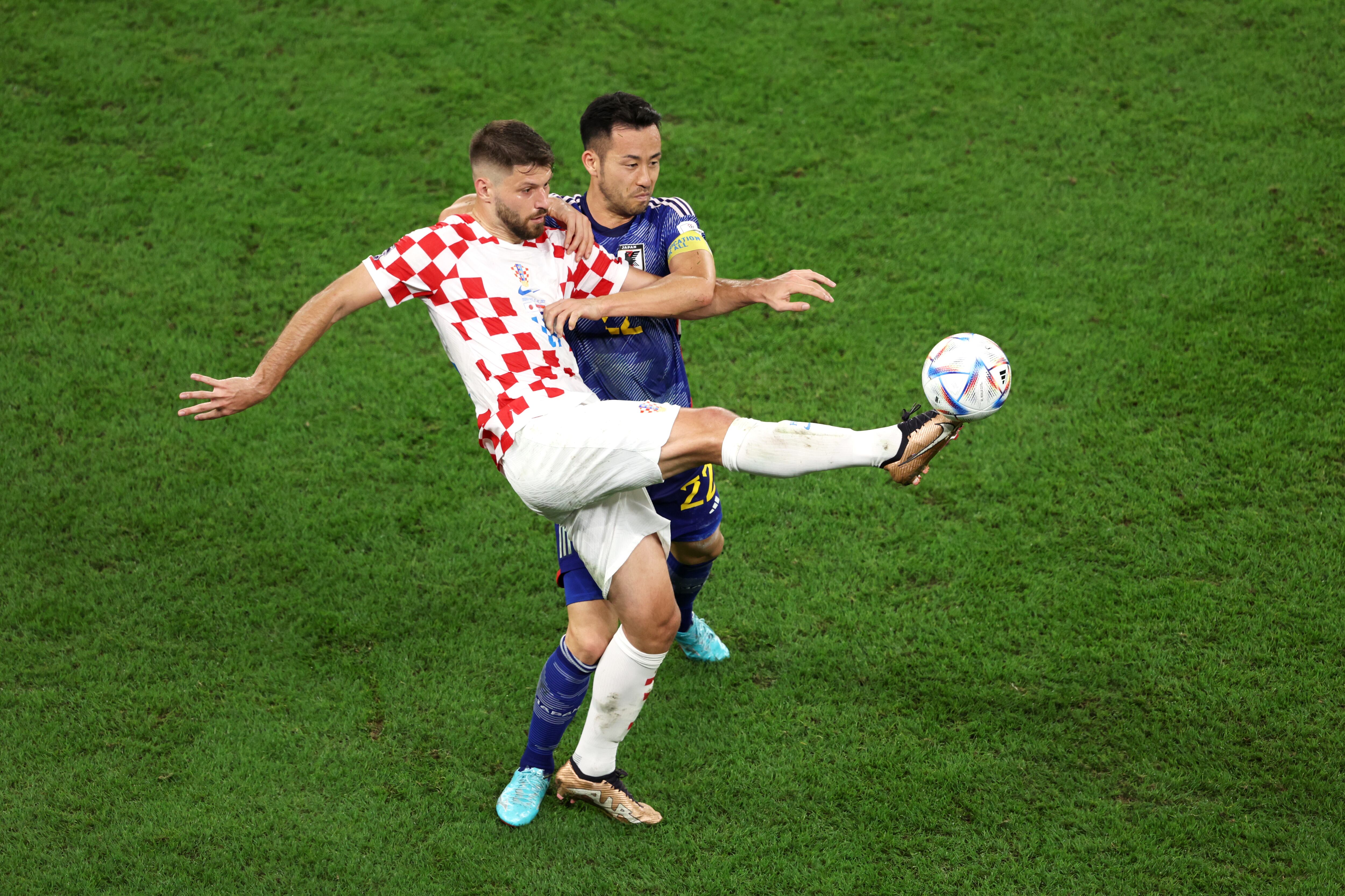 AL WAKRAH, QATAR - DECEMBER 05: Bruno Petkovic of Croatia battles for possession with Maya Yoshida of Japan during the FIFA World Cup Qatar 2022 Round of 16 match between Japan and Croatia at Al Janoub Stadium on December 05, 2022 in Al Wakrah, Qatar. (Photo by Clive Brunskill/Getty Images)