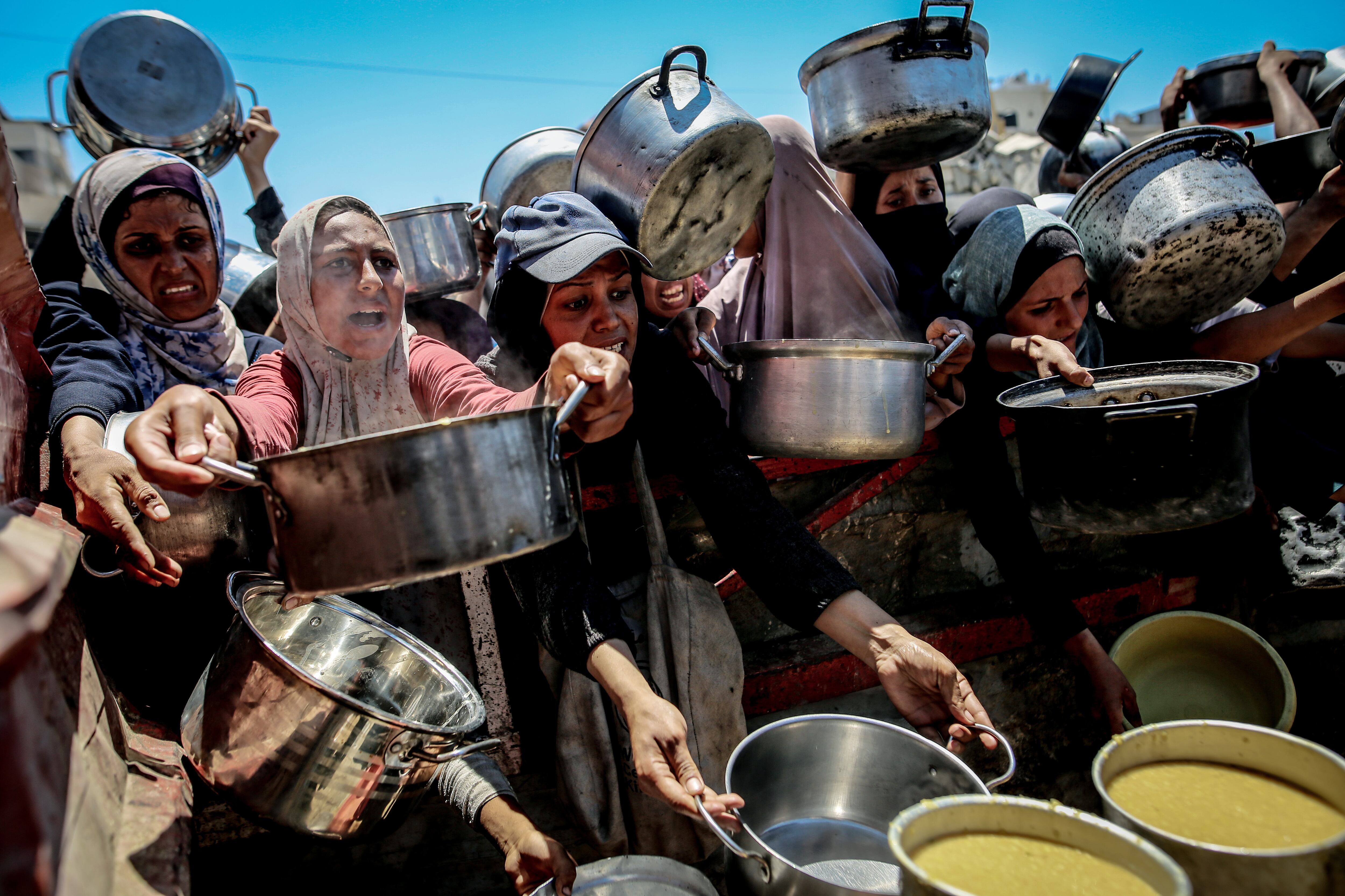 Palestinos, que tienen dificultades para acceder a alimentos debido al bloqueo impuesto por Israel, esperan para recibir comida caliente en la Franja de Gaza el 4 de agosto de 2025. (Foto de Saeed M. M. T. Jaras/Anadolu vía Getty Images)