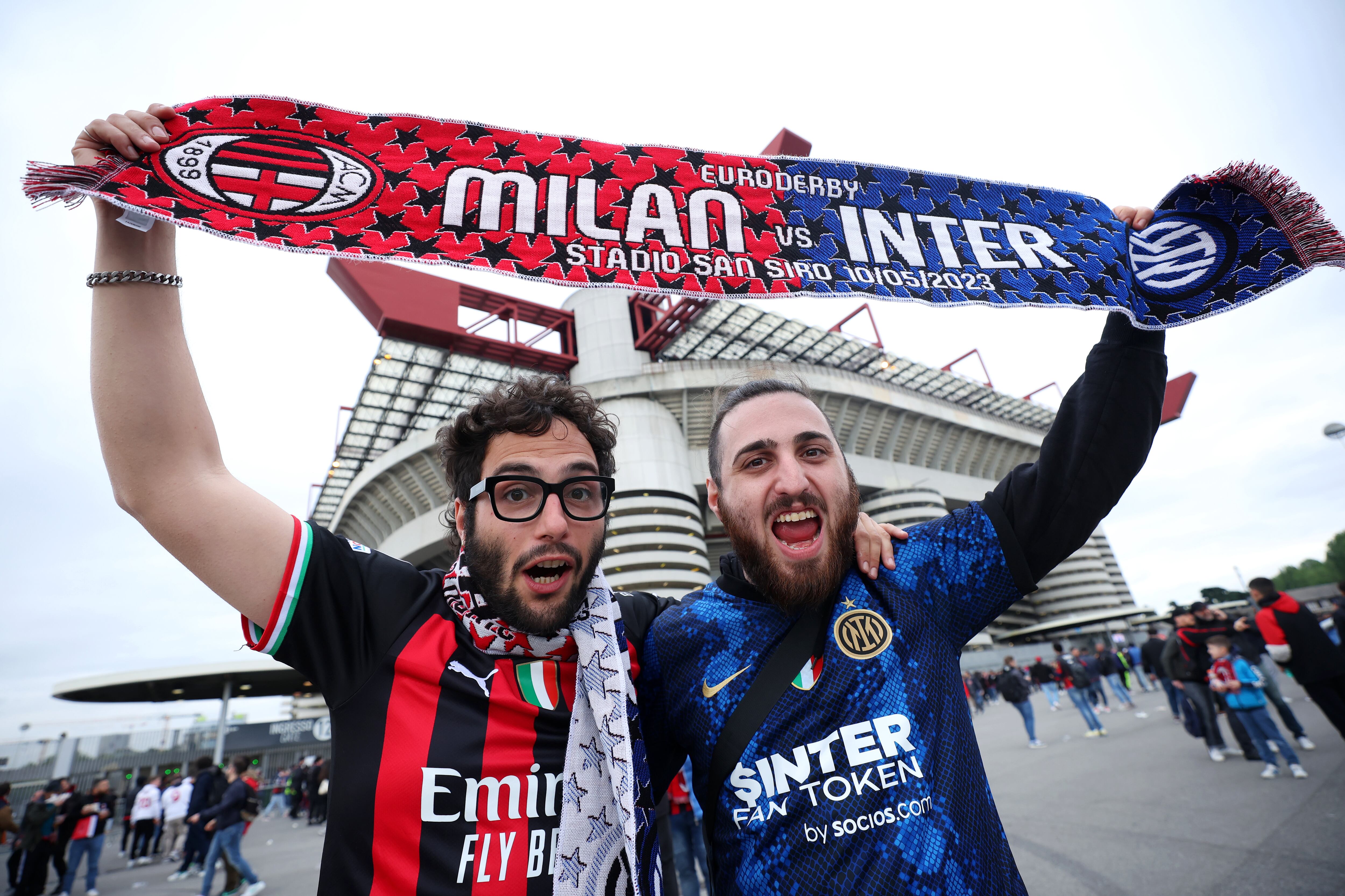 MILAN, ITALY - MAY 10: A fan of AC Milan and FC Internazionale pose for a photograph with a half and half scarf prior to the UEFA Champions League semi-final first leg match between AC Milan and FC Internazionale at San Siro on May 10, 2023 in Milan, Italy. (Photo by Alex Grimm/Getty Images)