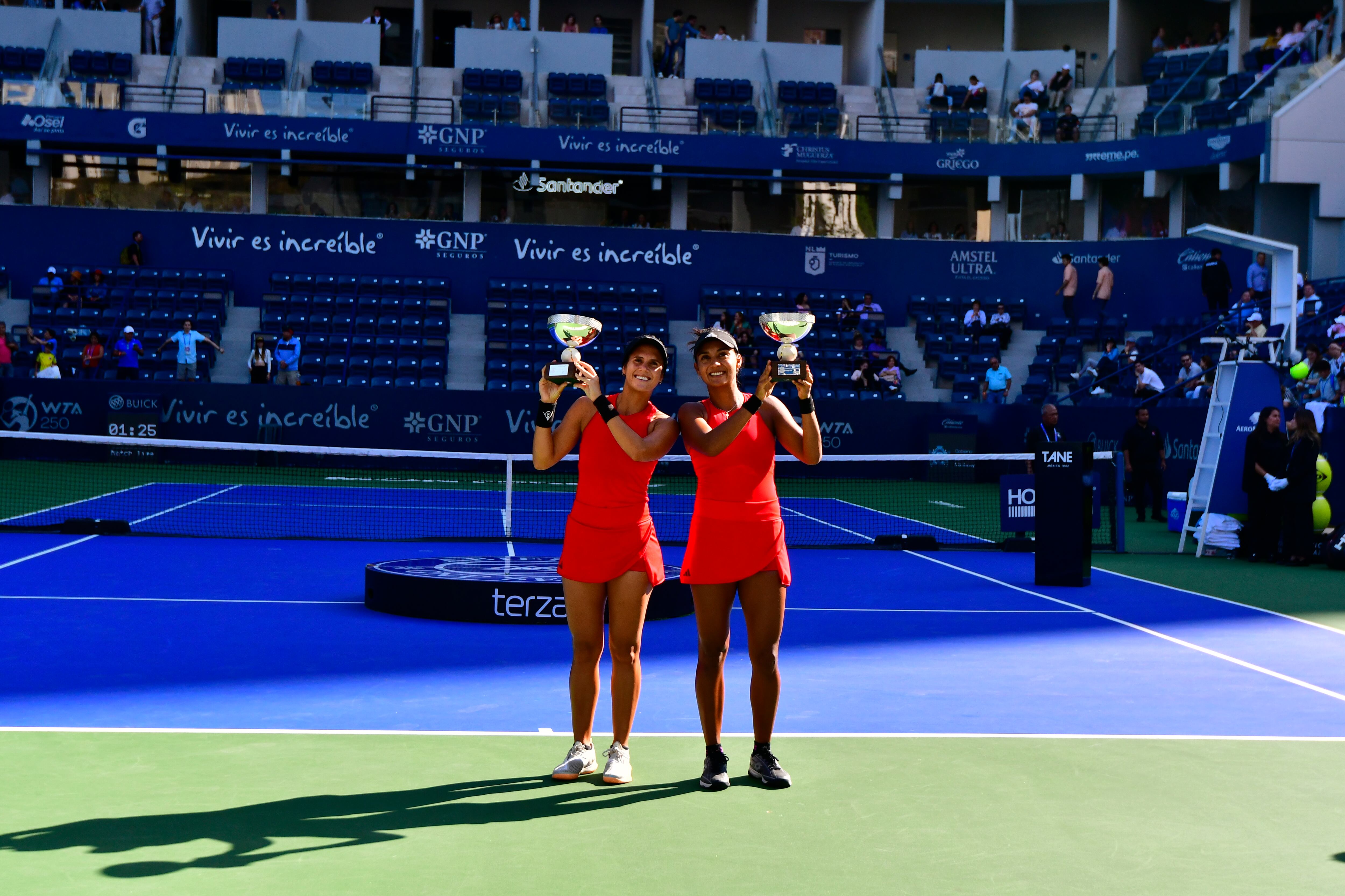 MONTERREY, MEXICO - MARCH 05: Yuliana Lizarazo and Maria Paulina Perez Garcia of Colombia lift the champion trophies after winning the final round doubles match against Kimberly Birrell of Australia and Fernanda Contreras of Mexico as part of the GNP Seguros WTA Monterrey Open 2023 at Estadio GNP Seguros on March 5, 2023 in Monterrey, Mexico. (Photo by Jaime Lopez/Jam Media/Getty Images)