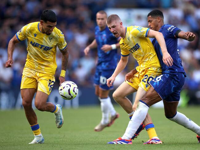 LONDON, ENGLAND - SEPTEMBER 01: Adam Wharton of Crystal Palace is tackled by Levi Colwill of Chelsea during the Premier League match between Chelsea FC and Crystal Palace FC at Stamford Bridge on September 01, 2024 in London, England. (Photo by Alex Pantling/Getty Images)