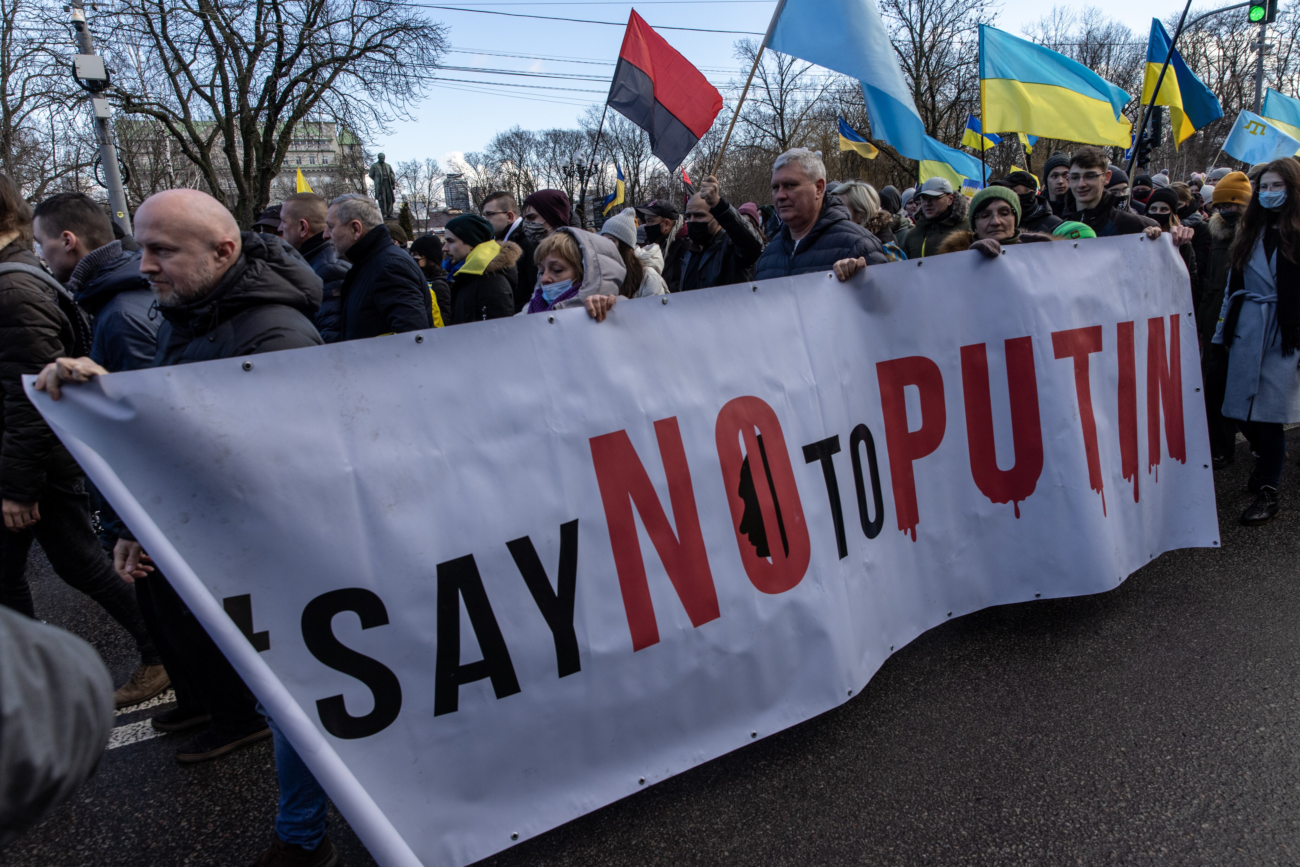 KYIV, UKRAINE - FEBRUARY 12: People participate in a Unity March to show solidarity and patriotic spirit over the escalating tensions with Russia on February 12, 2022 in Kiev, Ukraine. U.S President Joe Biden is scheduled to hold a phone call with Russian President Vladimir Putin in an attempt to bring down tensions over the possibility of an imminent Russian invasion of Ukraine.  (Photo by Chris McGrath/Getty Images)