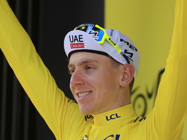 Bologna (Italy), 30/06/2024.- Slovenian rider Tadej Pogacar of UAE Team Emirates celebrates on the podium wearing the overall leader&#039;s yellow jersey after the second stage of the 2024 Tour de France cycling race over 199km from Cesenatico to Bologna, Italy, 30 June 2024. (Ciclismo, Francia, Italia, Eslovenia) EFE/EPA/GUILLAUME HORCAJUELO