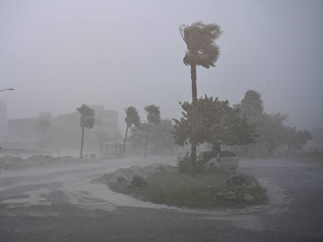 TOPSHOT - A car is seen parked as it rains heavily in Fort Myers, Florida, on October 9, 2024 as Hurricane Milton approaches. Milton regained power on October 8 to become a Category 5 storm with maximum sustained winds of 165 mph (270 kph) as it barrels towards the west-central coast of Florida and is forecast to make landfall late October 9, according to the National Hurricane Center. (Photo by CHANDAN KHANNA / AFP) (Photo by CHANDAN KHANNA/AFP via Getty Images)
