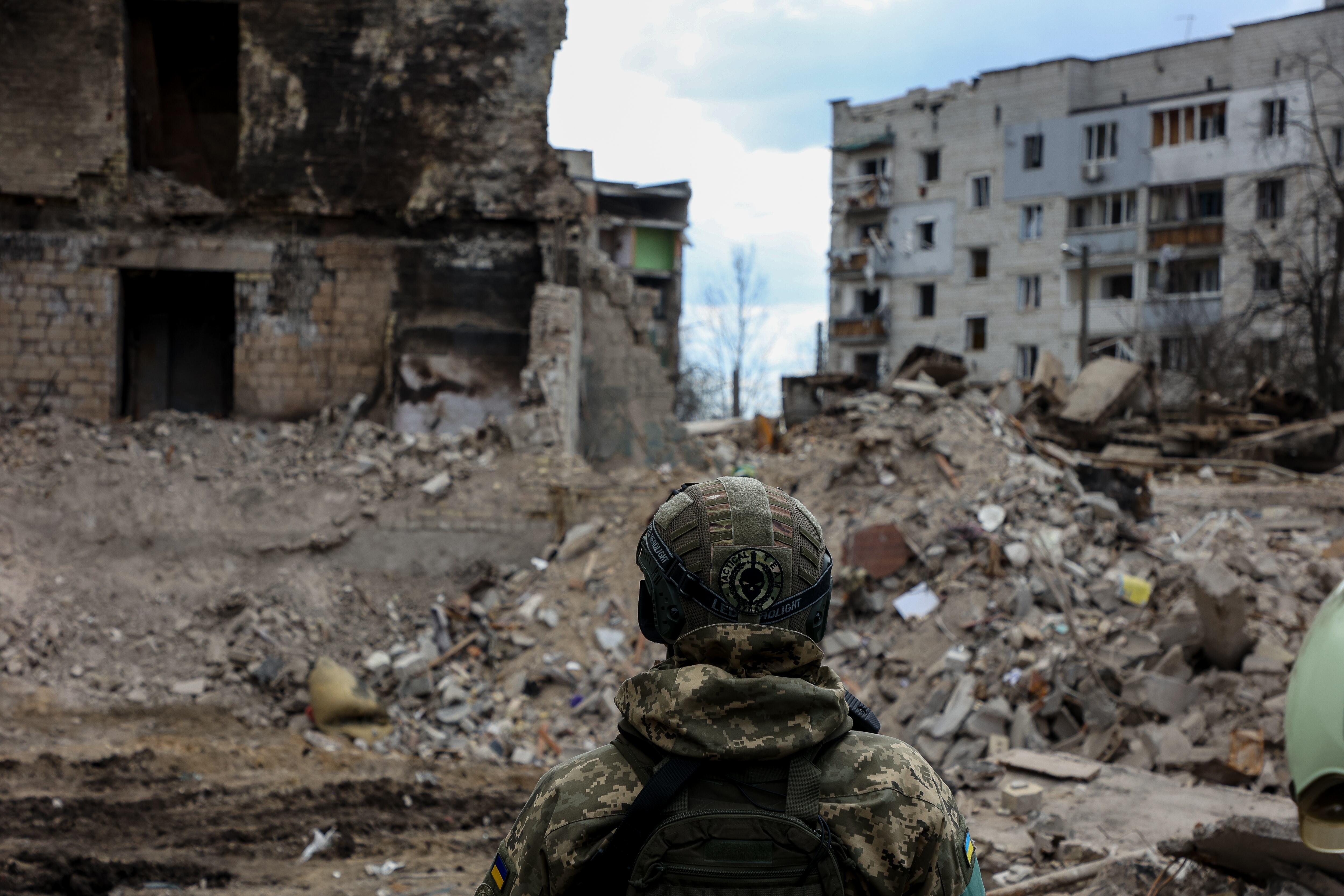 A military man looks at the rubbles of buildings destroyed by Russian shelling, amid Russia's Invasion of Ukraine, in Borodyanka, Kyiv region, Ukraine, April 11, 2022. (Photo by Sergii Kharchenko/NurPhoto via Getty Images)