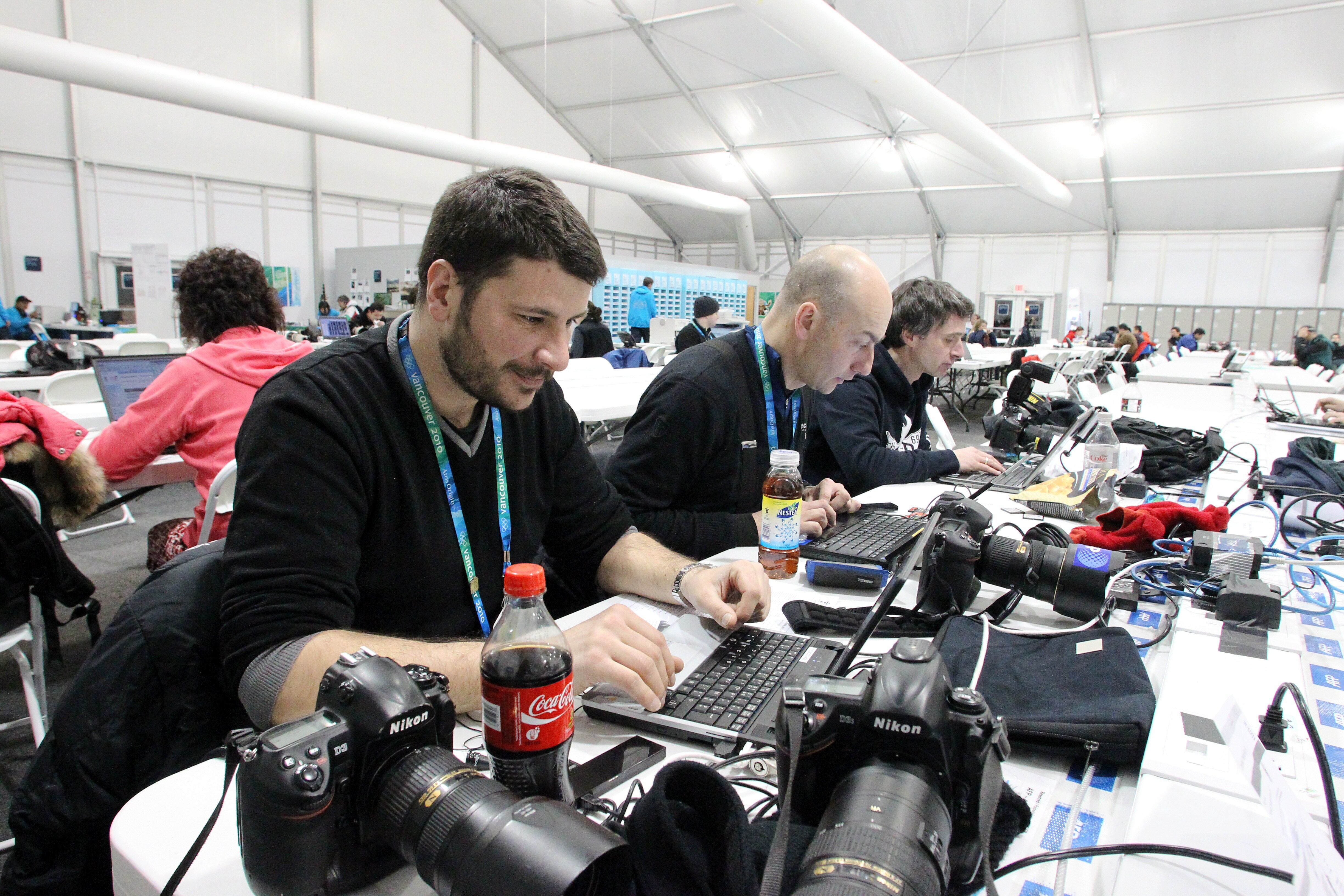 Photographers working in the Cypress Media Centre on Thursday, Feb. 25, 2010, during the Vancouver 2010 Olympic Winter Games. AFP PHOTO / STEPHANIE LAMY (Photo credit should read STEPHANIE LAMY/AFP via Getty Images)