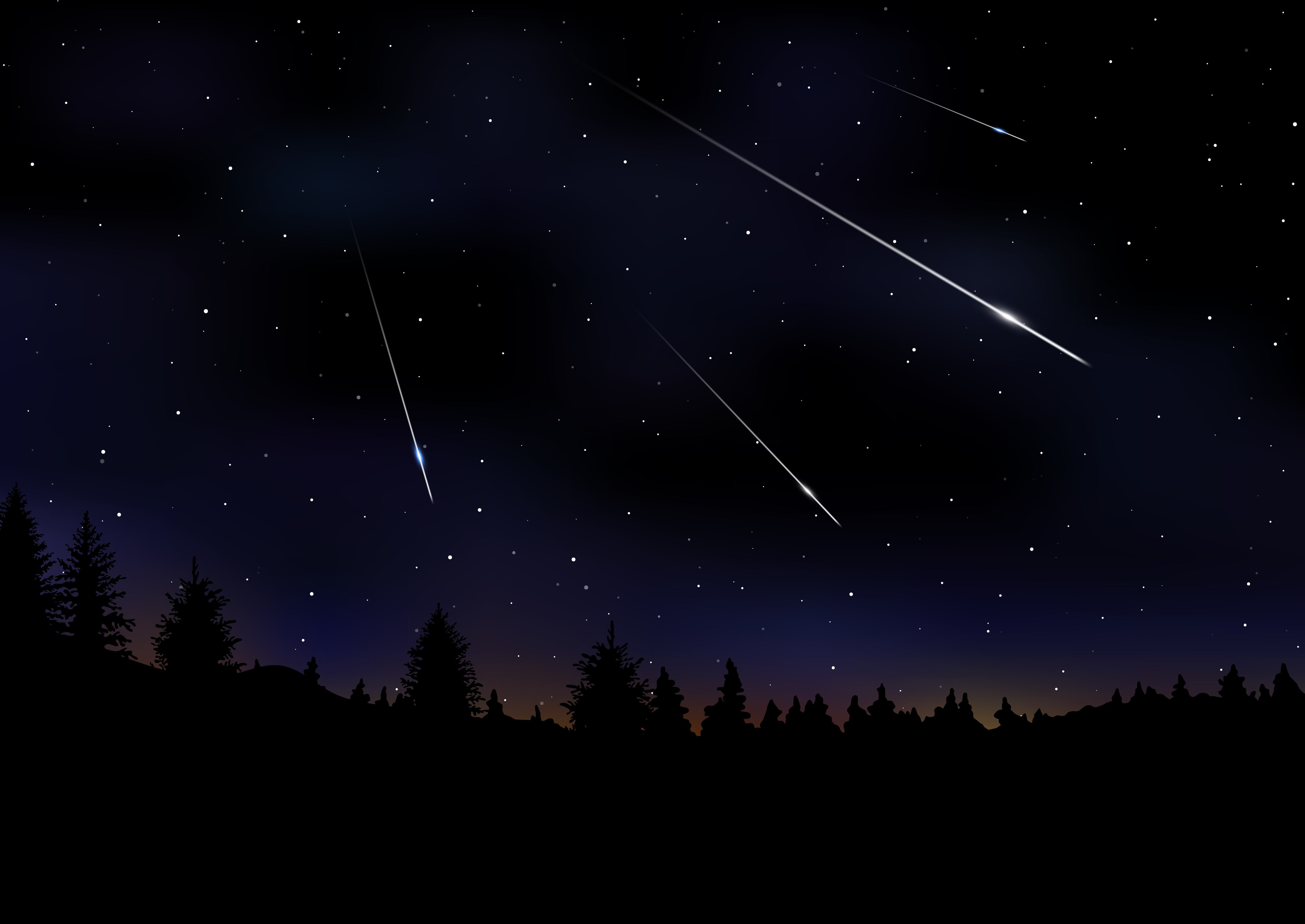 Lluvia de meteoritos perseidas que caen en el cielo nocturno oscuro vía Getty Images.