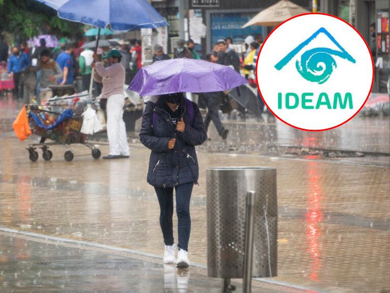 Mujer en Bogotá con sombrilla/ Getty Images