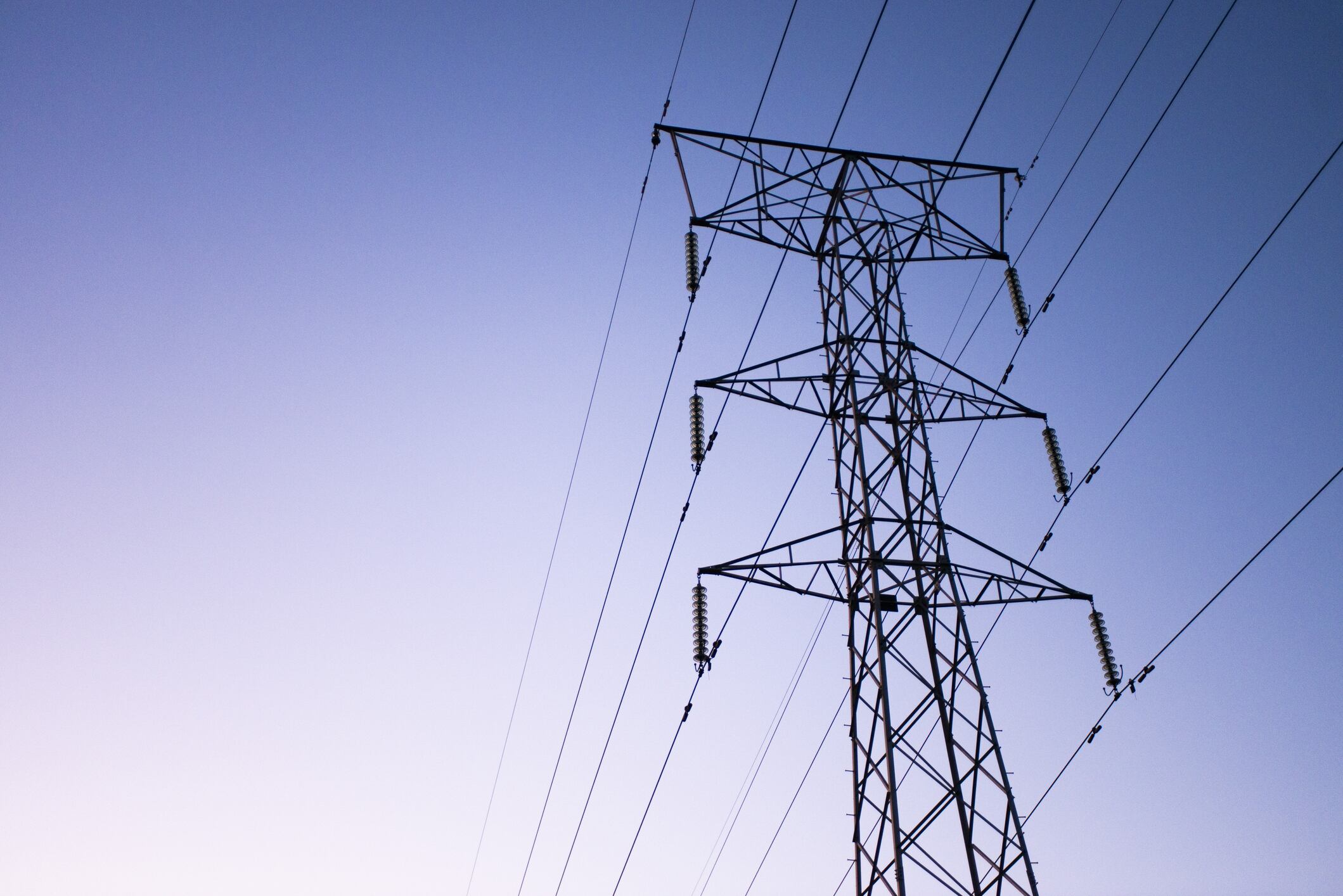 Electrical power lines at sunrise hang from a transmission pylon in Pretoria, South Africa, on Friday, May 31, 2019. Photographer: Waldo Swiegers/Bloomberg