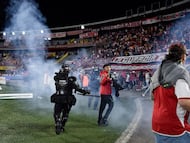 Miembros de la Policía intentando controlar a los hinchas que invadieron el estadio El Campín / Colprensa.