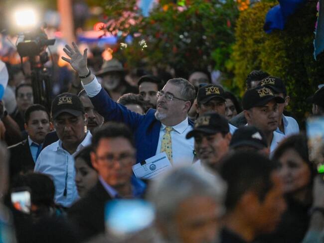 Guatemalan President-elect Bernardo Arevalo (C) waves to his supporters during a protest to demand the resignation of Attorney General Consuelo Porras and prosecutor Rafael Curruchiche in Guatemala City on September 18, 2023. Arevalo presented this Monday at the Supreme Court headquarters a request for the removal of Attorney General Consuelo Porras, whom he accuses of orchestrating a "coup d'état" to prevent him from assuming power in January. (Photo by Johan ORDONEZ / AFP) (Photo by JOHAN ORDONEZ/AFP via Getty Images)