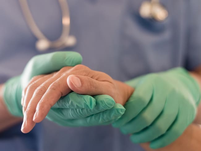 Surgeon, physician performs surgical operations, anesthetist or anesthesiologist holding patient&#039;s hand ffor checking state of mand or support in ER room, Medical healthcare concept
