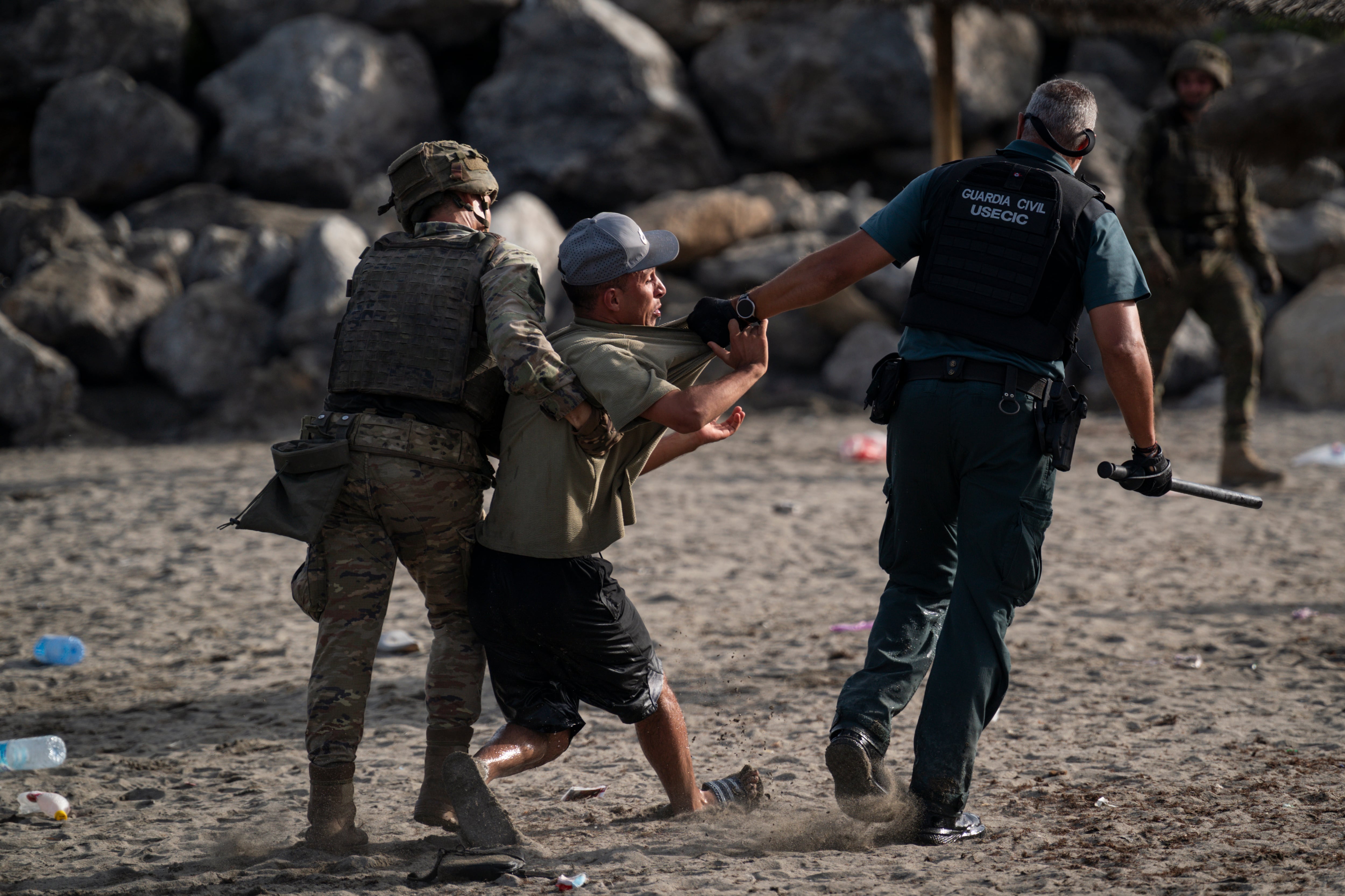 Un miembro de la Guardia Civil detiene a un migrante que ingresó irregularmente a España en Ceuta.
(Foto: Adri Salido/Getty Images)