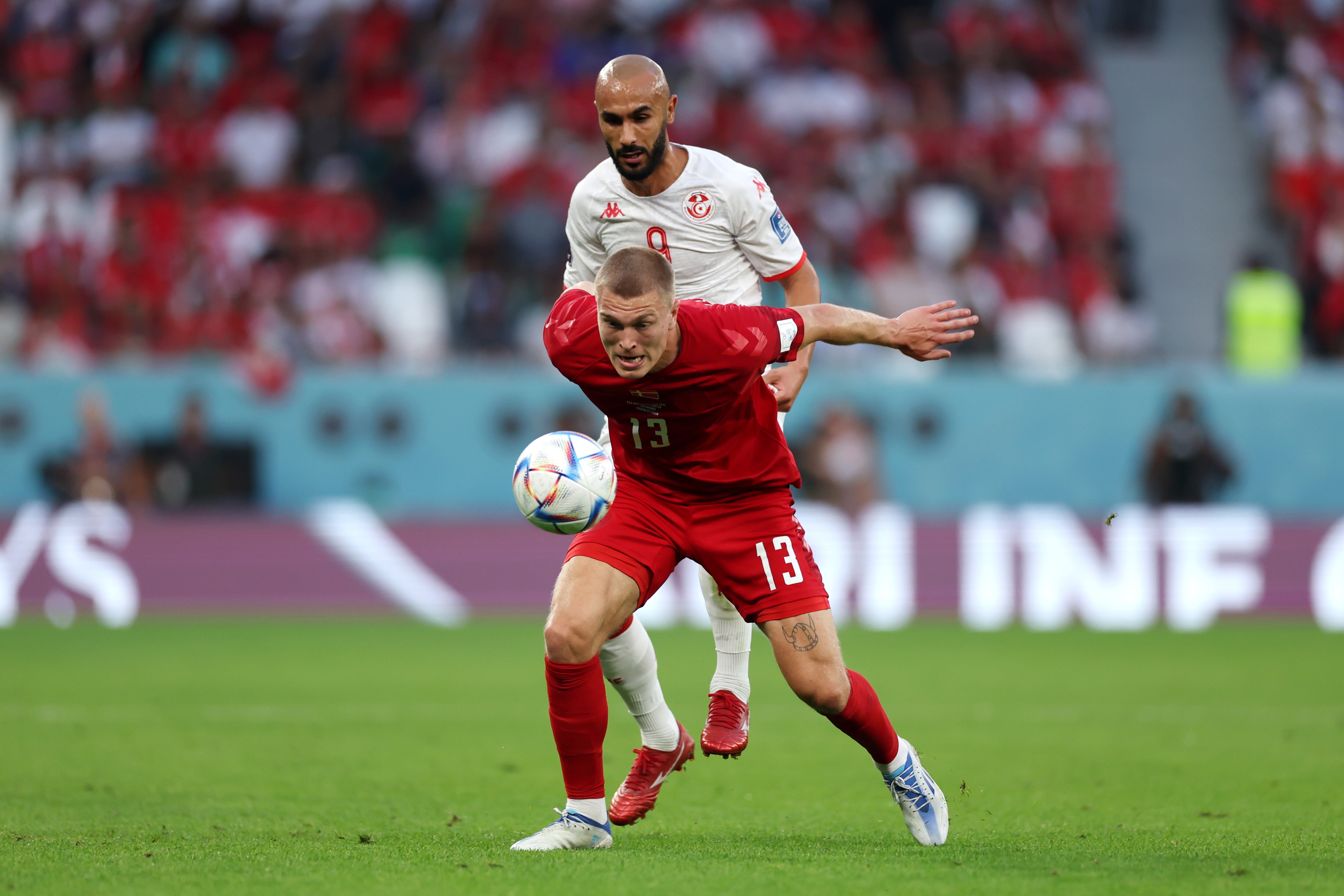 AL RAYYAN, QATAR - NOVEMBER 22: Rasmus Kristensen of Denmark controls the ball against Issam Jebali of Tunisia during the FIFA World Cup Qatar 2022 Group D match between Denmark and Tunisia at Education City Stadium on November 22, 2022 in Al Rayyan, Qatar. (Photo by Lars Baron/Getty Images)