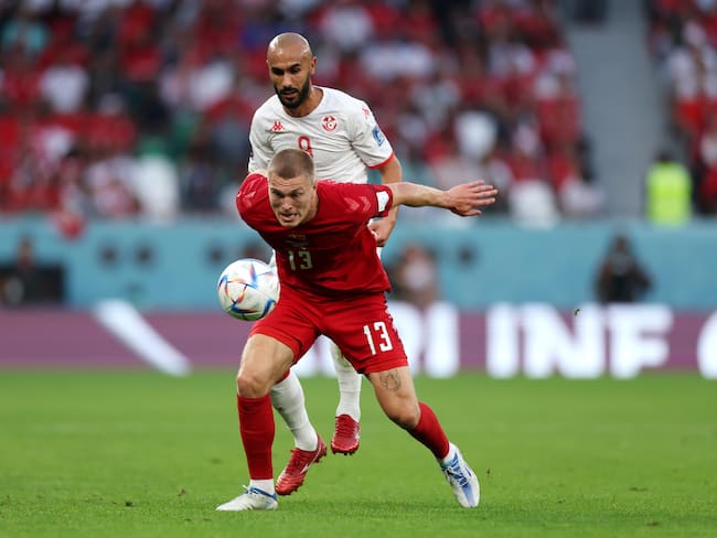 AL RAYYAN, QATAR - NOVEMBER 22: Rasmus Kristensen of Denmark controls the ball against Issam Jebali of Tunisia during the FIFA World Cup Qatar 2022 Group D match between Denmark and Tunisia at Education City Stadium on November 22, 2022 in Al Rayyan, Qatar. (Photo by Lars Baron/Getty Images)
