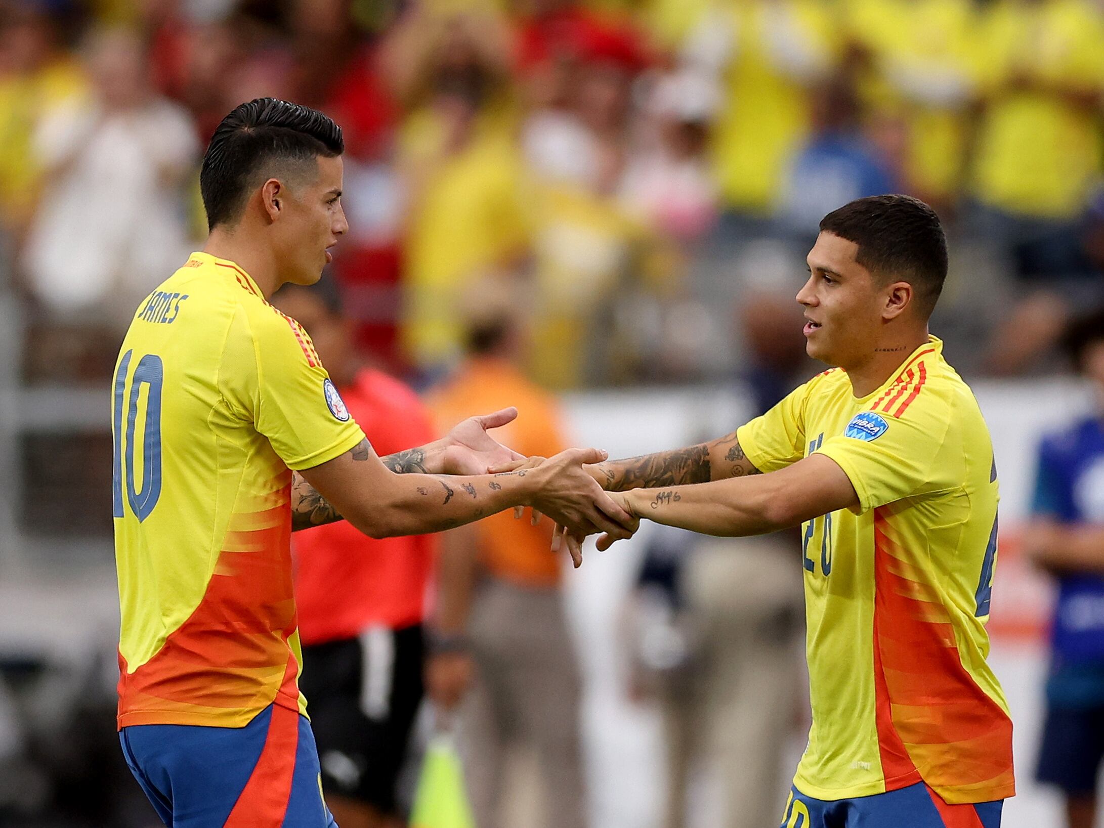 GLENDALE, ARIZONA - JULY 06: James Rodriguez of Colombia shakes hands with Juan Fernando Quintero of Colombia in a substitution during the CONMEBOL Copa America 2024 quarter-final match between Colombia and Panama at State Farm Stadium on July 06, 2024 in Glendale, Arizona. (Photo by Jamie Squire/Getty Images)