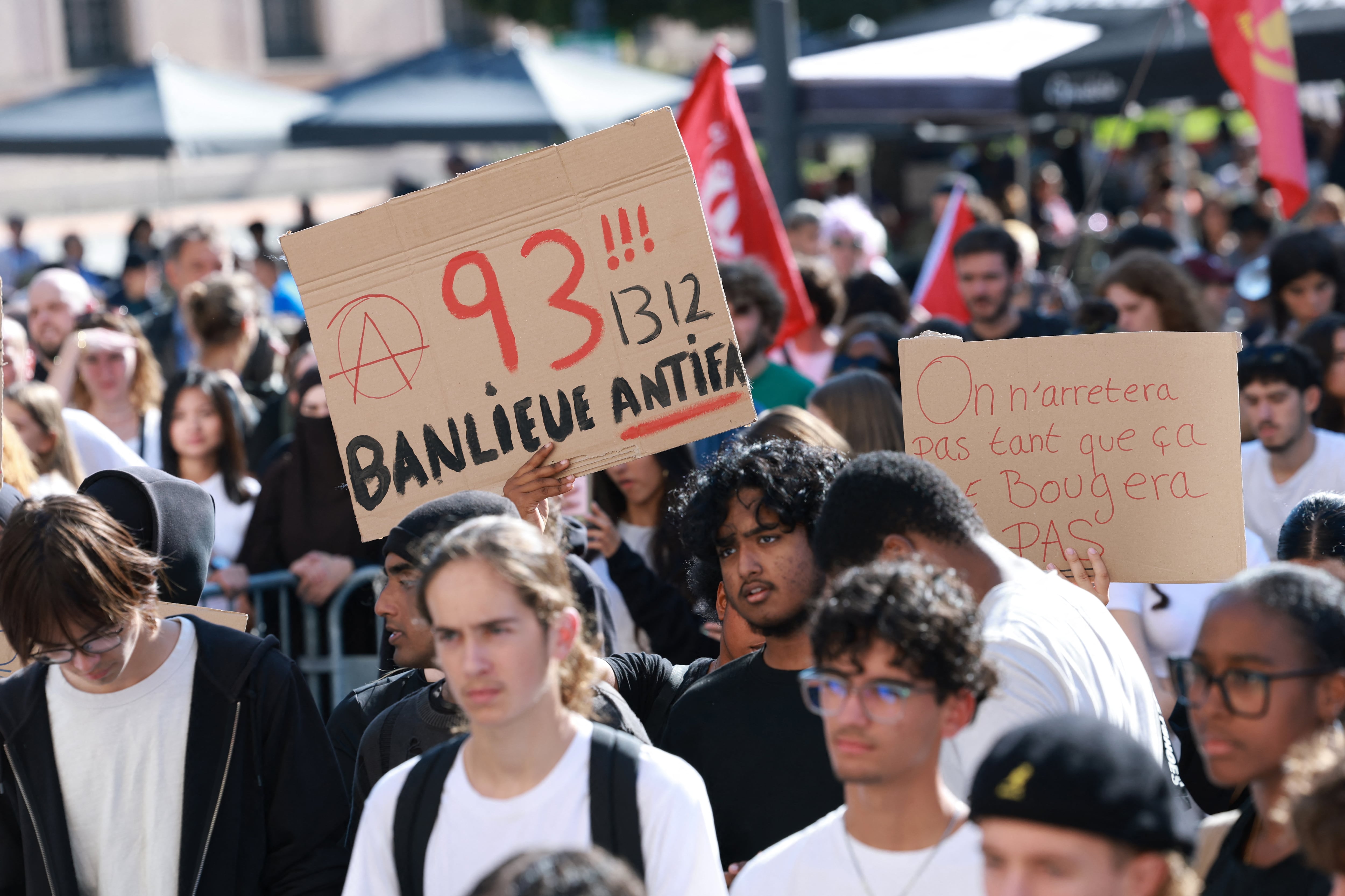 high school students hold a placard which reads as '"93 (93, suburb antifascist 1312" (1312 being the numeric code for the the abbreviation ACAB, a slogan for All Cops are Bastards), during a gathering amid a nationwide protest movement over school conditions in Saint-Denis, north of Paris, on October 4, 2026. Up to 500 schools across France will be totally or partly closed on October 5 due to the protests by teenage pupils that have shaken the country. movement. The teens at French high schools, known as lyc�es, say that their studies are being ruined by high teacher absences, overlong school days and dilapidated facilities as well as other grievances. (Photo by Kenzo TRIBOUILLARD / AFP)