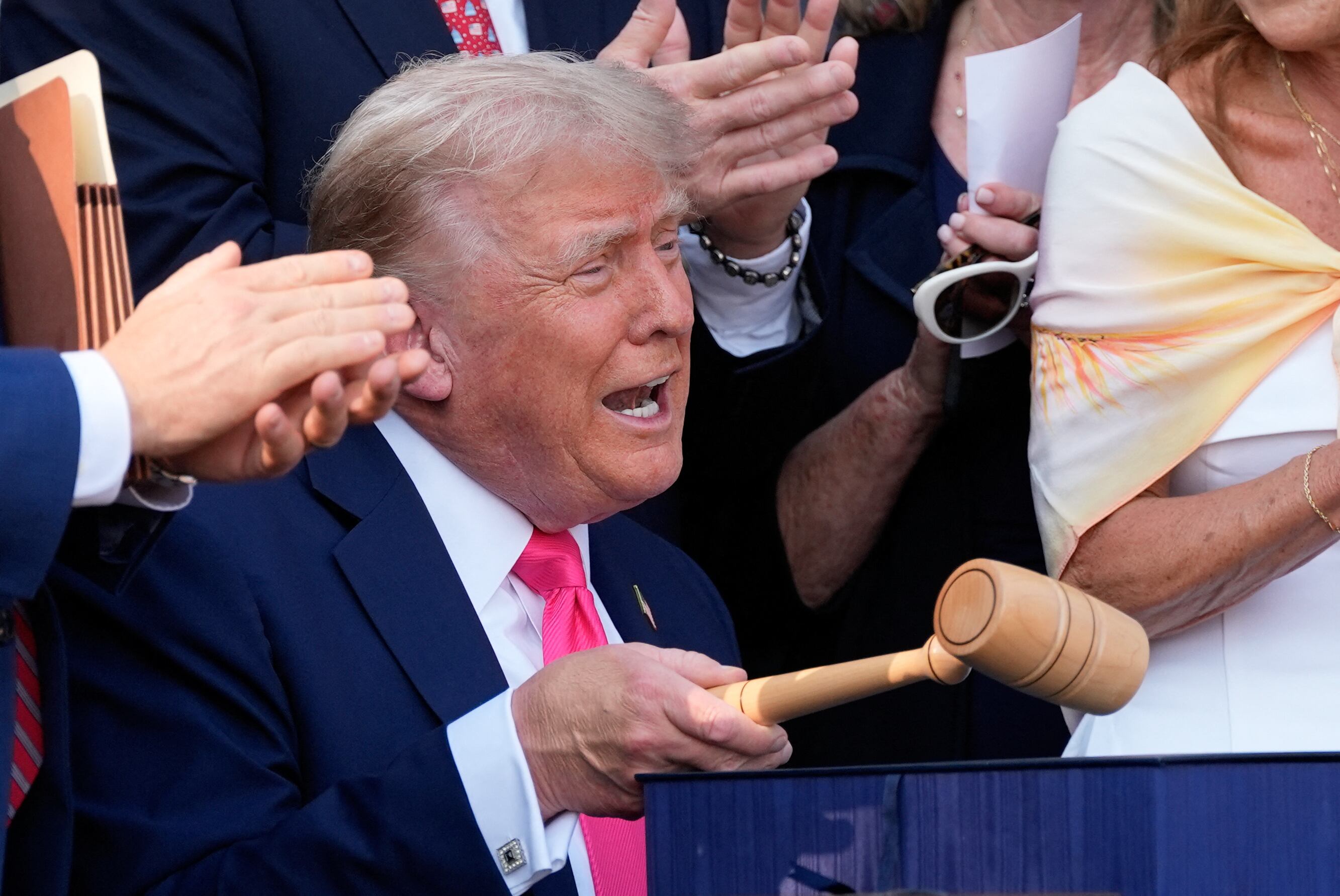 US President Donald Trump bangs a gavel after signing his signature bill of tax breaks and spending cuts "Big Beautiful Bill" on the South Lawn of the White House in Washington, DC on July 4, 2025. (Photo by Alex Brandon / POOL / AFP) (Photo by ALEX BRANDON/POOL/AFP via Getty Images)          