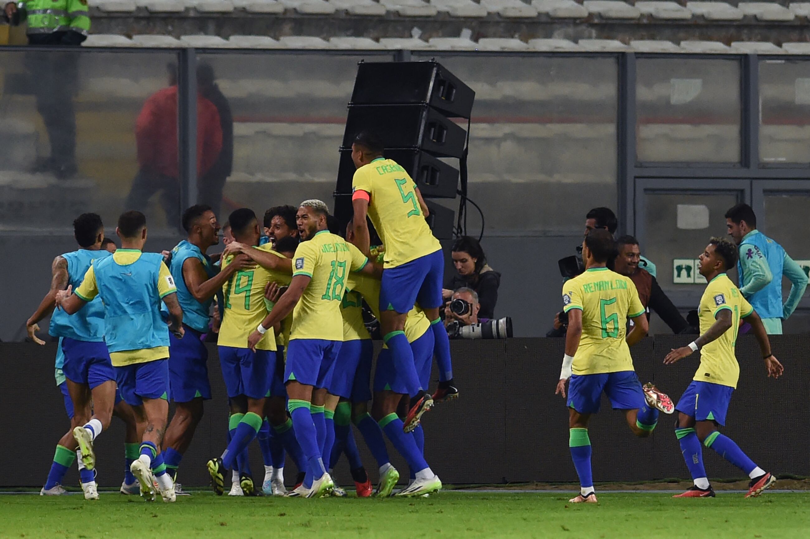 Brazilian players celebrate a goal scored by teammate defender Marquinhos (covered) during the 2026 FIFA World Cup South American qualifiers football match between Peru and Brazil, at the Nacional stadium in Lima, on September 12, 2023. (Photo by CRIS BOURONCLE / AFP) (Photo by CRIS BOURONCLE/AFP via Getty Images)