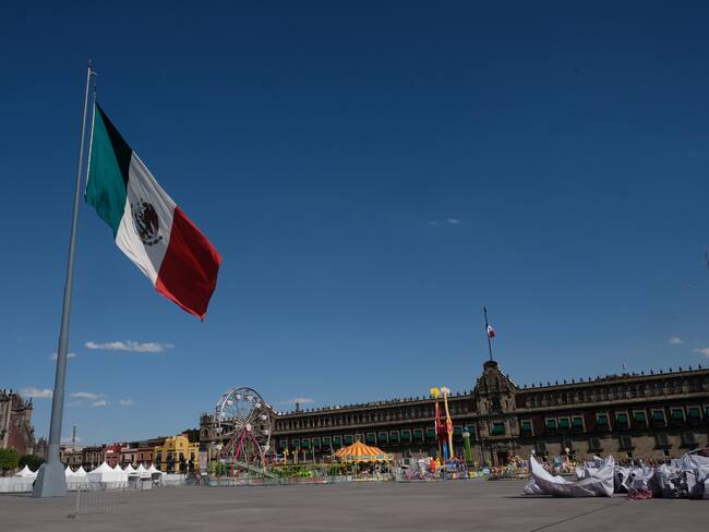 MEXICO CITY, MEXICO - JANUARY 3, 2023: The wind blows in the Mexican Flag raised in Constitution Square opposite the Presidential Palace on January 3, 2023 in Mexico City, Mexico. (Photo by Kaveh Kazemi/Getty Images)