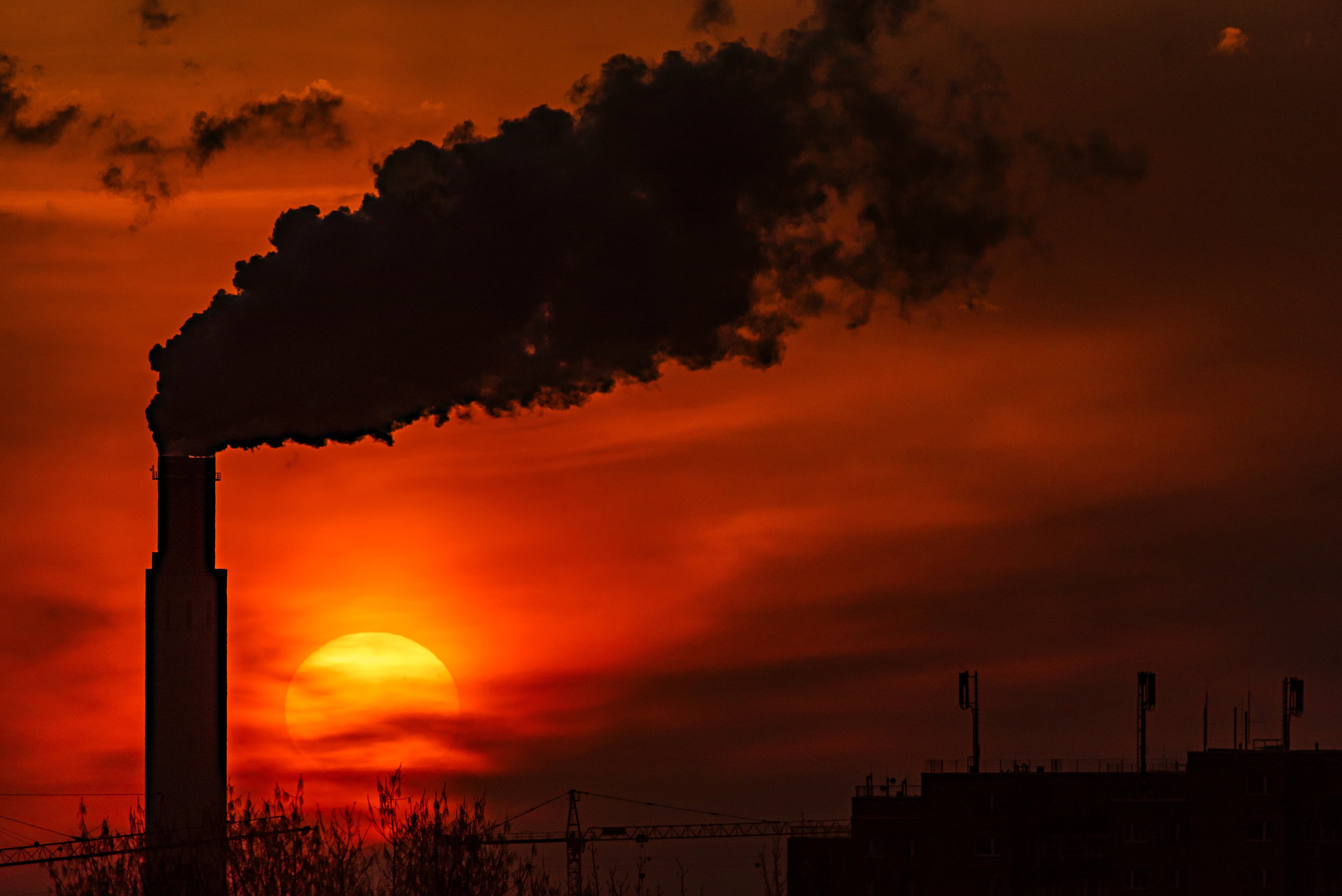 Sunrise behind a combined heat and power plant