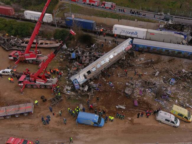 This aerial drone photograph taken on March 1, 2023, shows emergency crews examining the wreckage after a train accident in the Tempi Valley near Larissa, Greece. - At least 32 people were killed and another 85 injured after a collision between two trains caused a derailment near the Greek city of Larissa late at night on February 28, 2023, authorities said. A fire services spokesman confirmed that three carriages skipped the tracks just before midnight after the trains -- one for freight and the other carrying 350 passengers - collided about halfway along the route between Athens and Thessaloniki. (Photo by STRINGER / AFP) (Photo by STRINGER/AFP via Getty Images)