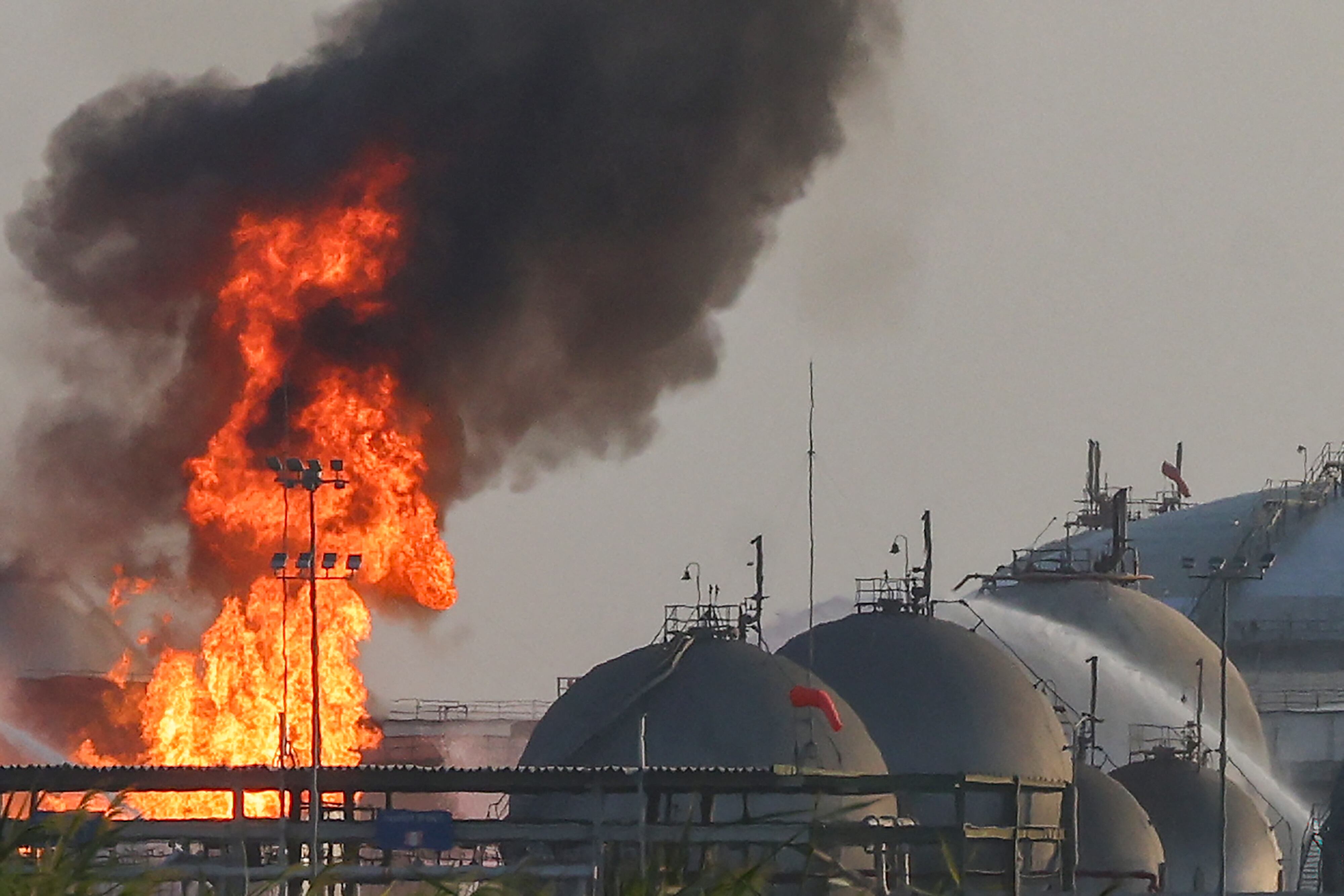 Flames burn at a facility belonging to Saudi oil giant Aramco south of Riyadh on October 3, 2026. The circumstances remained unclear but in recent weeks Aramco, majority-owned by the Saudi state, has come under attack from the Houthi authorities targeting the kingdom as part of the war in Yemen where Riyadh is backing the internationally recognised government. An AFP journalist reported seeing fire engines attempting to extinguish a blaze at the energy giant's Riyadh refinery, located south of the capital, while ambulances and police vehicles were stationed near the facility. (Photo by AFP) / 