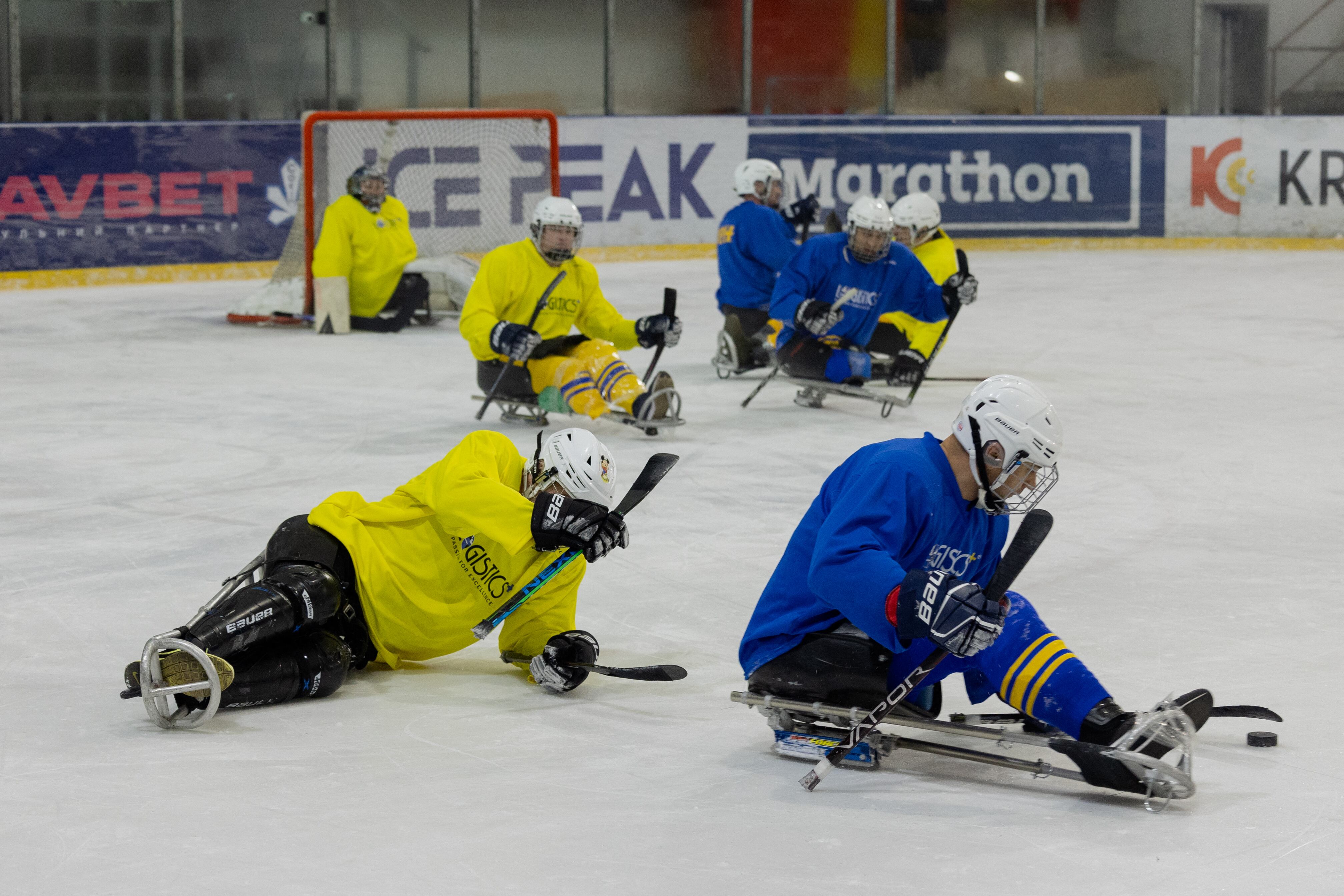 Team members, consisting of Ukrainian military veterans, athletes, and enthusiasts, participate in a para ice hockey training organized by the Ukrainian Para Ice Hockey Federation at the ATEK Ice Arena in Kyiv on November 19, 2025, amid the Russian invasion of Ukraine. Para hockey, or sledge hockey, is an adaptive form of hockey in which players � bearing amputations or lower limb impairments � move across the ice on special sleds called sledges. Such training helps to build a community around inclusive sports, which promotes the rehabilitation and social adaptation of veterans, and is also a step towards creating a permanent national para hockey league and forming a Ukrainian national team for this sport. (Photo by Tetiana DZHAFAROVA / AFP)