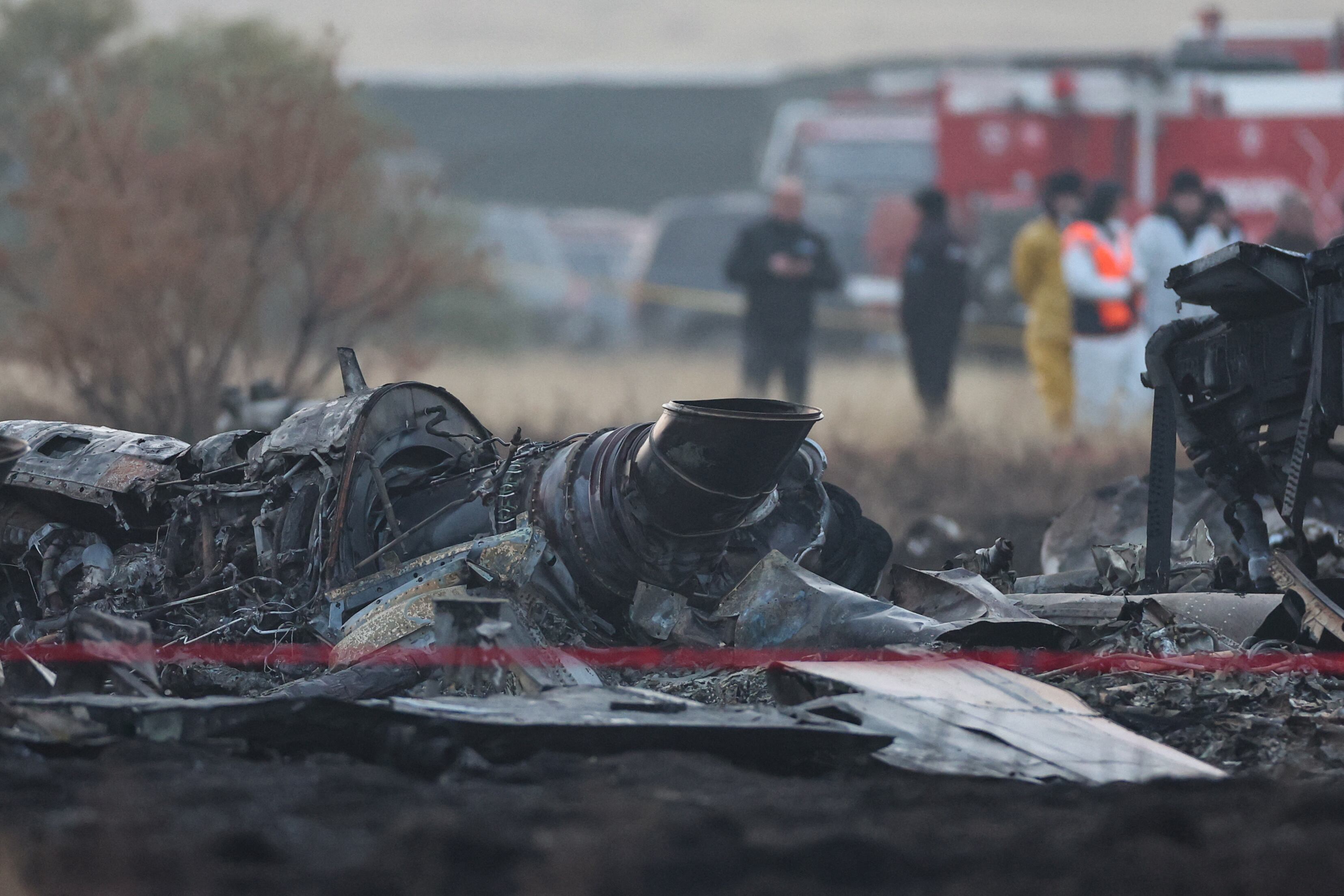 Wreckage is seen at the crash site of the Turkish C-130 military cargo plane in the Sighnaghi area at the Georgia-Azerbaijan border on November 12, 2025. A Turkish military cargo plane carrying 20 passengers and crew crashed in Georgia on its way home from Azerbaijan, the defence ministry said Tuesday. (Photo by Giorgi ARJEVANIDZE / AFP)