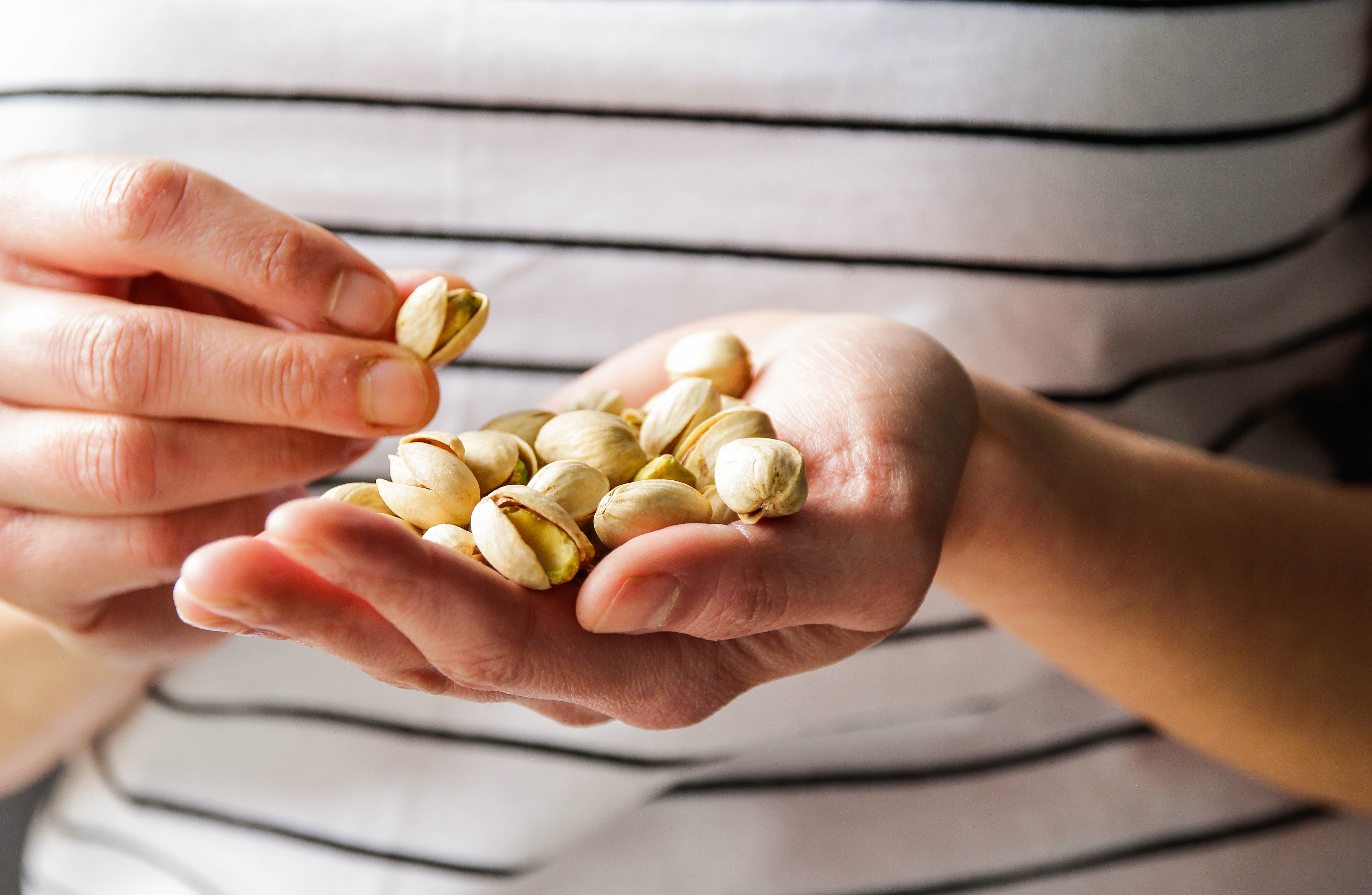 Persona con pistachos en su mano (Foto vía Getty Images)
