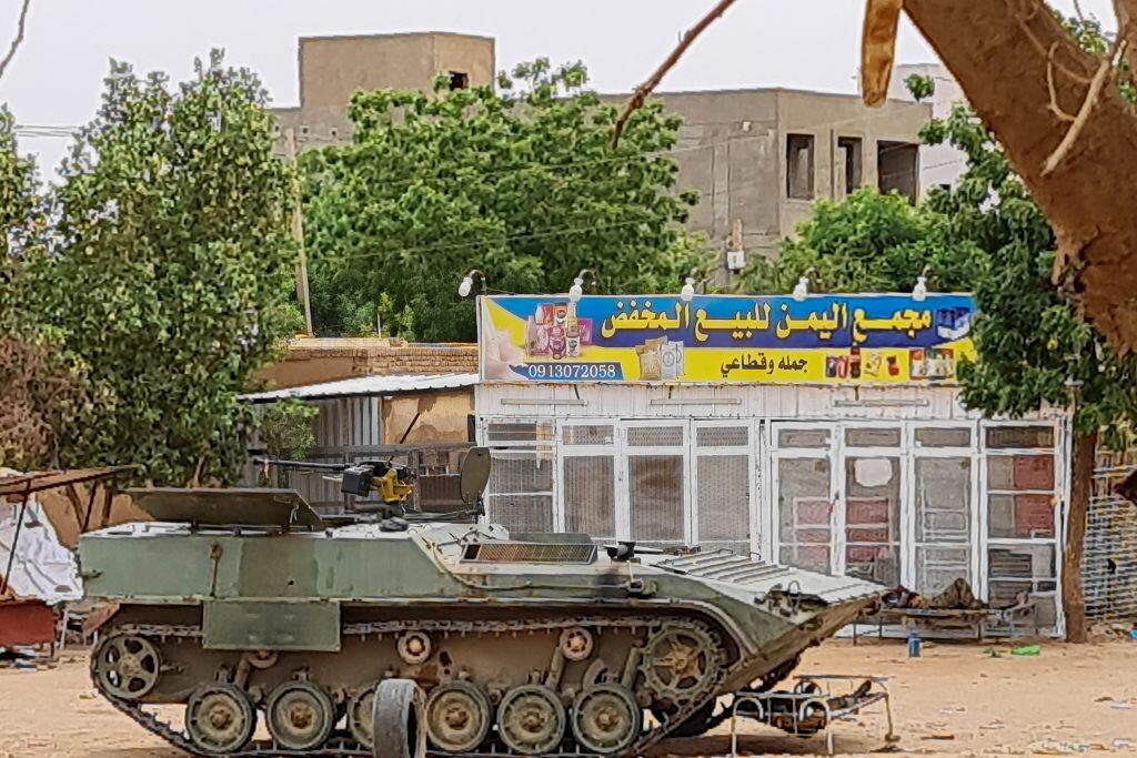 Sudanese Army soldiers rest near a tank at a checkpoint in Khartoum on April 30, 2023, as clashes continue in war-torn Sudan. - Heavy fighting again rocked Sudan's capital on April 30, as tens of thousands have fled the bloody turmoil and a former prime minister warned of the "nightmare" risk of a descent into full-scale civil war. (Photo by AFP) (Photo by -/AFP via Getty Images)