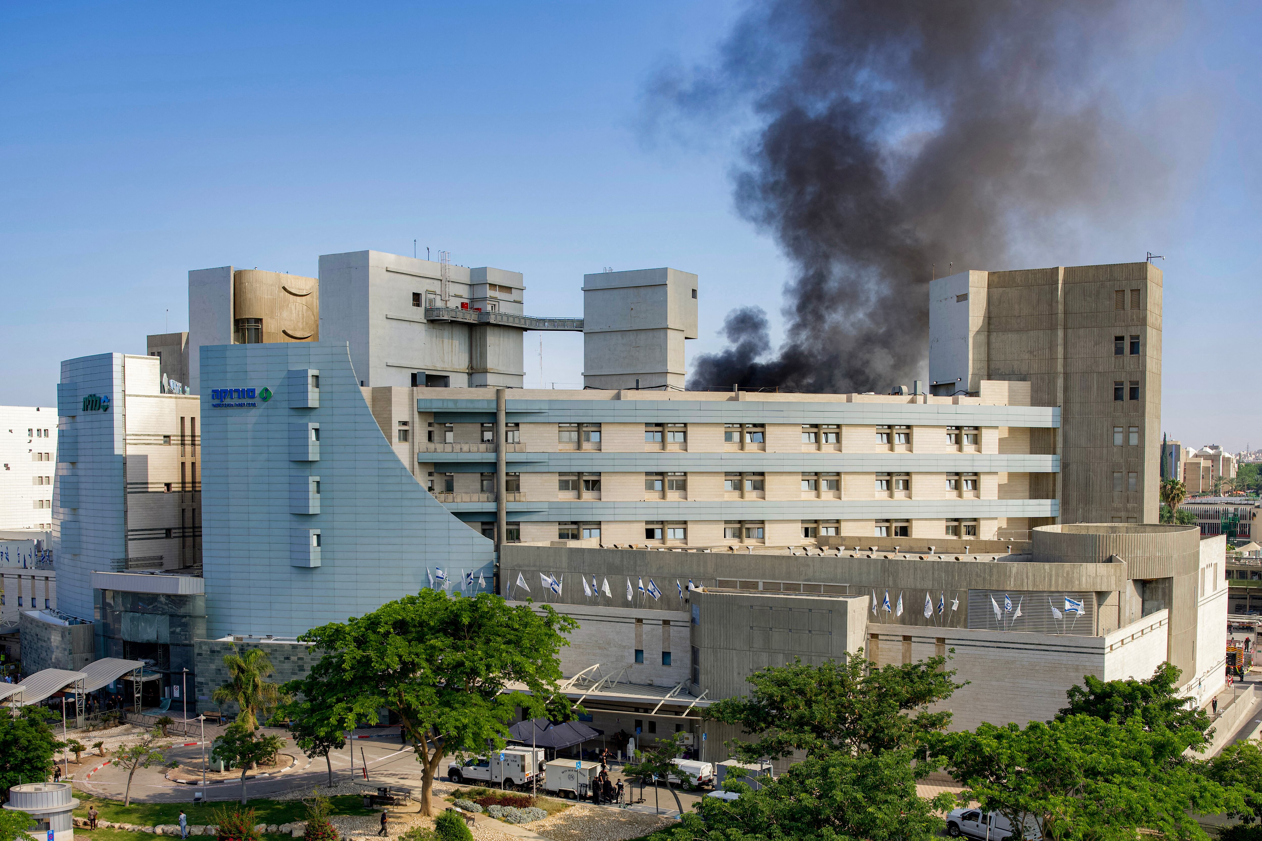 Smoke billows from a building at Soroka Hospital in Beersheba in southern Israel following an Iranian missile attack, on June 19, 2025. A hospital in southern Israel was hit during a barrage of "dozens" of Iranian missiles on June 19, officials said, while another impact was reported by emergency services in the Tel Aviv area. (Photo by MAYA LEVIN / AFP)