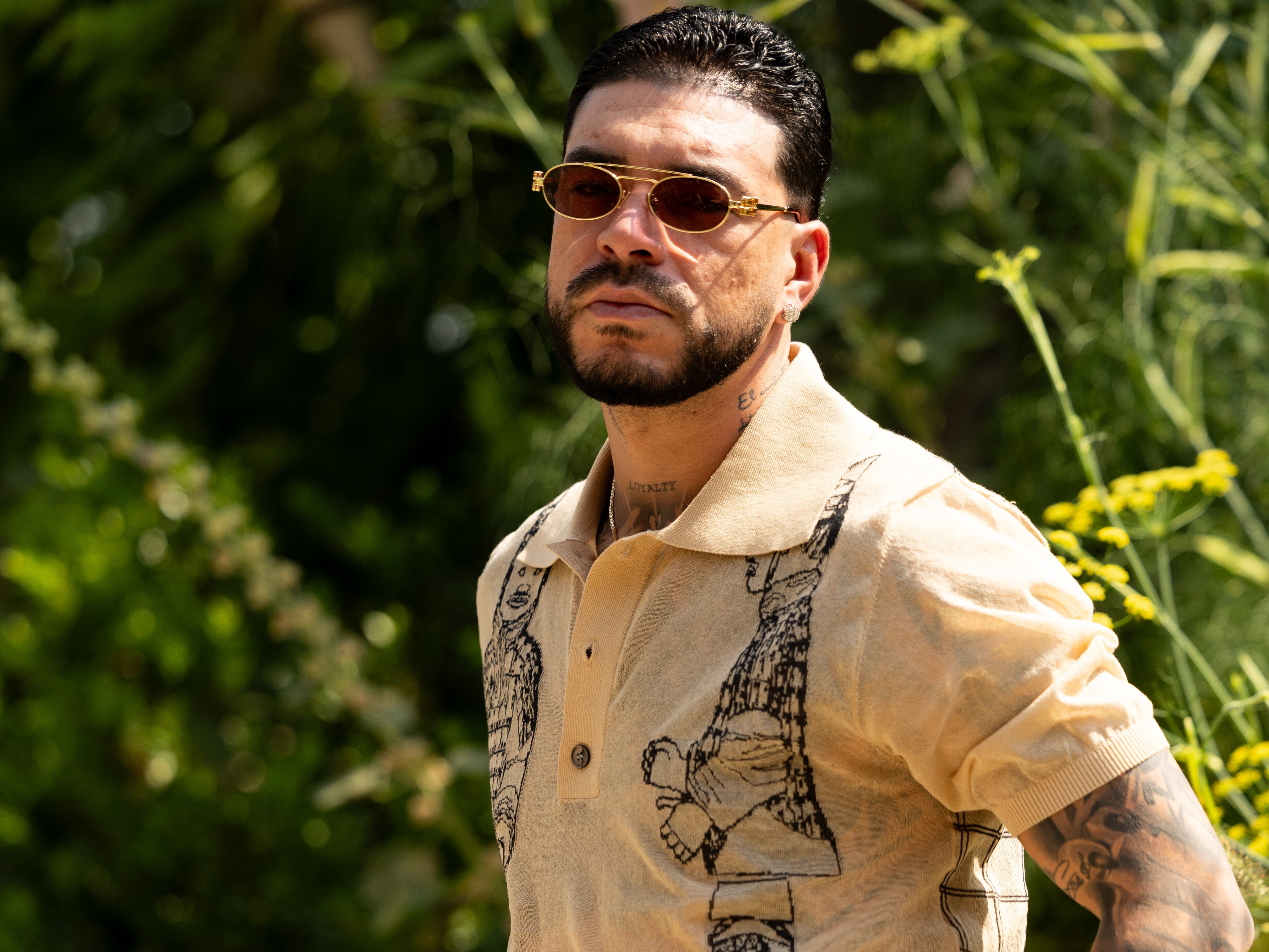 MILAN, ITALY - JUNE 20: Ryan Castro wears beige sunglasses, a beige and black printed short sleeved shirt, a black leather belt and brown wide leg trousers outside Pronounce during the Milan Fashion Week - Menswear Spring/Summer 2027 on June 20, 2026 in Milan, Italy. (Photo by Valentina Frugiuele/Getty Images)