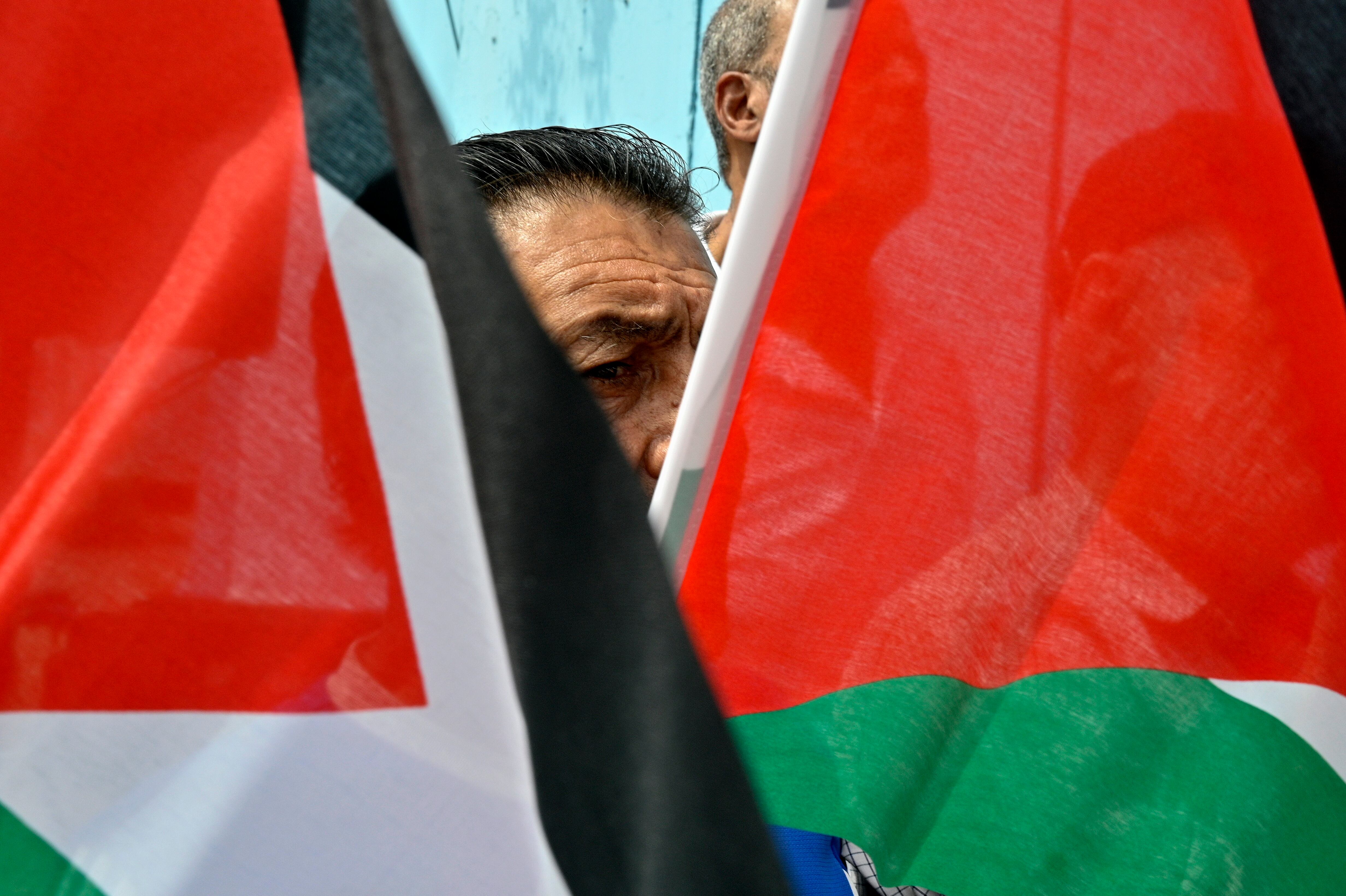 Beirut (Lebanon), 28/05/2024.- A Palestinian man carries Palestinian flags during a protest in solidarity with Gaza and UNRWA employees organized by the Palestinian and Islamic forces outside the UNRWA offices in Beirut, Lebanon, 28 May 2024.