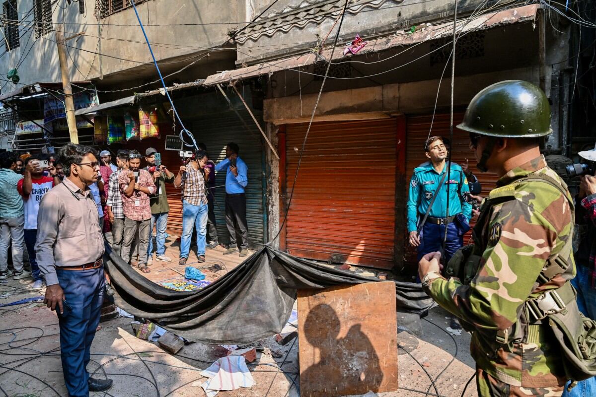 An army personnel stands guard near the rubble that fell from a damaged building following an earthquake in Old Dhaka on November 21, 2025. A powerful earthquake struck Bangladesh on November 21 outside the crowded capital Dhaka, killing at least three people and injuring many others, health officials said. (Photo by Munir UZ ZAMAN / AFP)