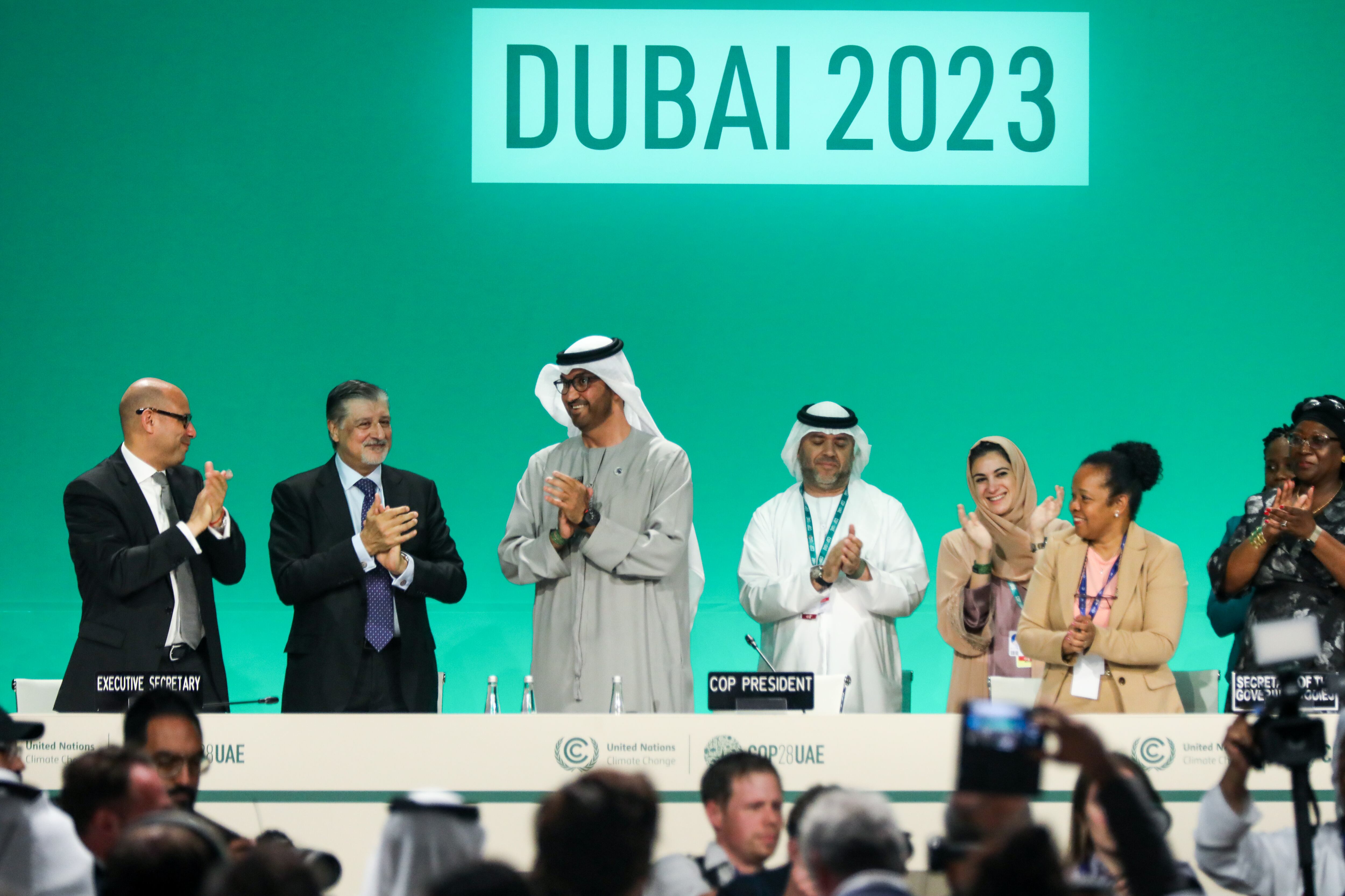 DUBAI, UNITED ARAB EMIRATES - DECEMBER 13: Delegates applaud after a speech by Sultan Ahmed Al Jaber (3L), President of the UNFCCC COP28 Climate Conference, during a plenary session on day thirteen of the UNFCCC COP28 Climate Conference on December 13, 2023 in Dubai, United Arab Emirates. The conference has gone into an extra day as delegations continue to negotiate over the wording of the final agreement. The COP28, which was originally scheduled to run from November 30 through December 12, has brought together stakeholders, including international heads of state and other leaders, scientists, environmentalists, indigenous peoples representatives, activists and others to discuss and agree on the implementation of global measures towards mitigating the effects of climate change. (Photo by Fadel Dawod/Getty Images)