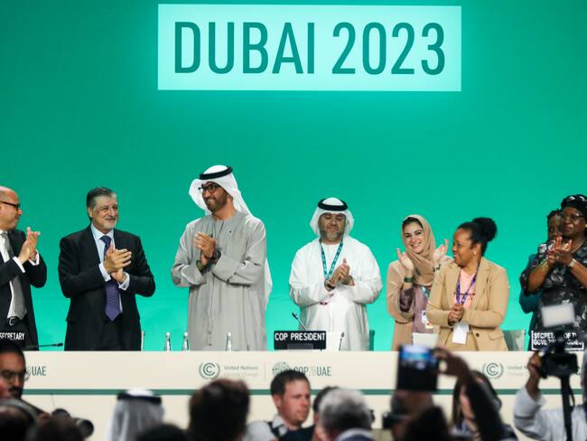 DUBAI, UNITED ARAB EMIRATES - DECEMBER 13: Delegates applaud after a speech by Sultan Ahmed Al Jaber (3L), President of the UNFCCC COP28 Climate Conference, during a plenary session on day thirteen of the UNFCCC COP28 Climate Conference on December 13, 2023 in Dubai, United Arab Emirates. The conference has gone into an extra day as delegations continue to negotiate over the wording of the final agreement. The COP28, which was originally scheduled to run from November 30 through December 12, has brought together stakeholders, including international heads of state and other leaders, scientists, environmentalists, indigenous peoples representatives, activists and others to discuss and agree on the implementation of global measures towards mitigating the effects of climate change. (Photo by Fadel Dawod/Getty Images)