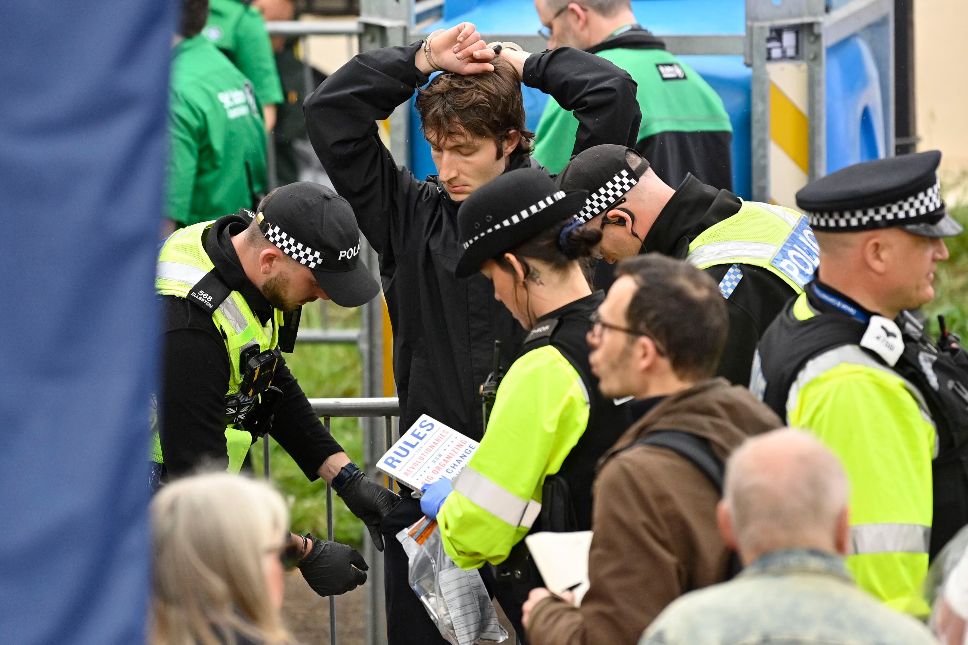LONDON, ENGLAND - MAY 06: Protesters from climate protest group 'Just Stop Oil' are apprehended by police officers in the crowd close to where Britain's King Charles III and Britain's Camilla, Queen Consort will be crowned at Westminster Abbey on May 6, 2023 in London, England. The set-piece coronation is the first in Britain in 70 years, and only the second in history to be televised. Charles will be the 40th reigning monarch to be crowned at the central London church since King William I in 1066. (Photo by Justin Tallis - WPA Pool/Getty Images)