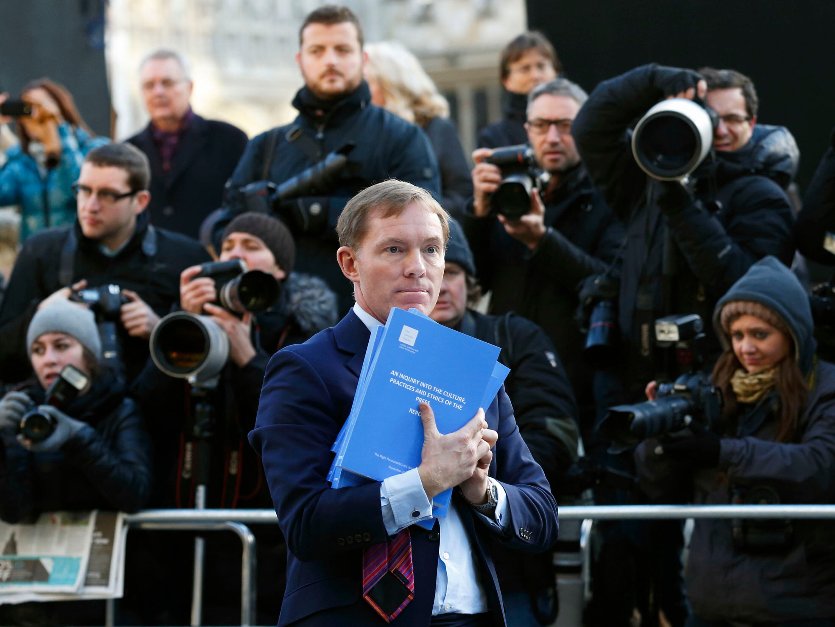 British opposition Labour member of parliament Chris Bryant poses for photographers with a copy of the Leveson Report into press ethics in central London on November 29, 2012 published after a major inquiry launched in the wake of the News Of The World phone-hacking scandal. A major inquiry called for new laws to underpin a tougher watchdog for Britain's "outrageous" newspapers in a move that threatens to split Prime Minister David Cameron's coalition government. AFP PHOTO / JUSTIN TALLIS        (Photo credit should read JUSTIN TALLIS/AFP via Getty Images)