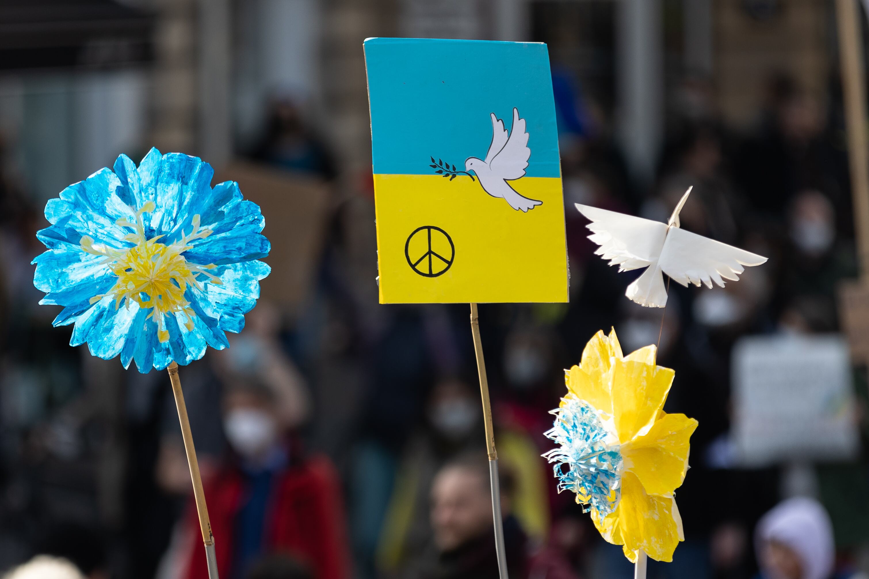 13 March 2022, Hessen, Frankfurt/Main: Signs with peace dove and flowers in the colors of Ukraine are held up. Under the slogan "Stop the war! Peace and solidarity for the people of Ukraine", a broad alliance of more than 50 organizations had called for large-scale demonstrations in several German cities. Photo: Hannes P. Albert/dpa (Photo by Hannes P. Albert/picture alliance via Getty Images)